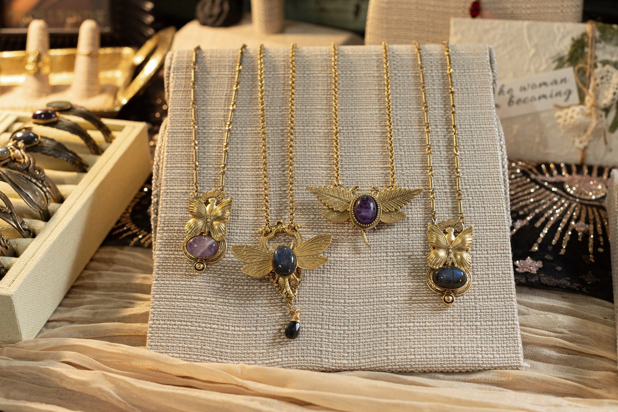 Gold and crystal jewelry displayed on a retail shelf at Libra Rising in Skippack, Pennsylvania.
