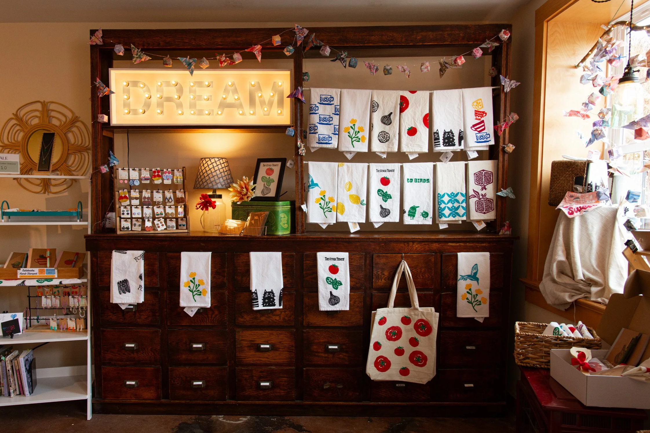 Handmade gifts, tea towels and jewelry displayed inside Wondering Time in Skippack, Pennsylvania.