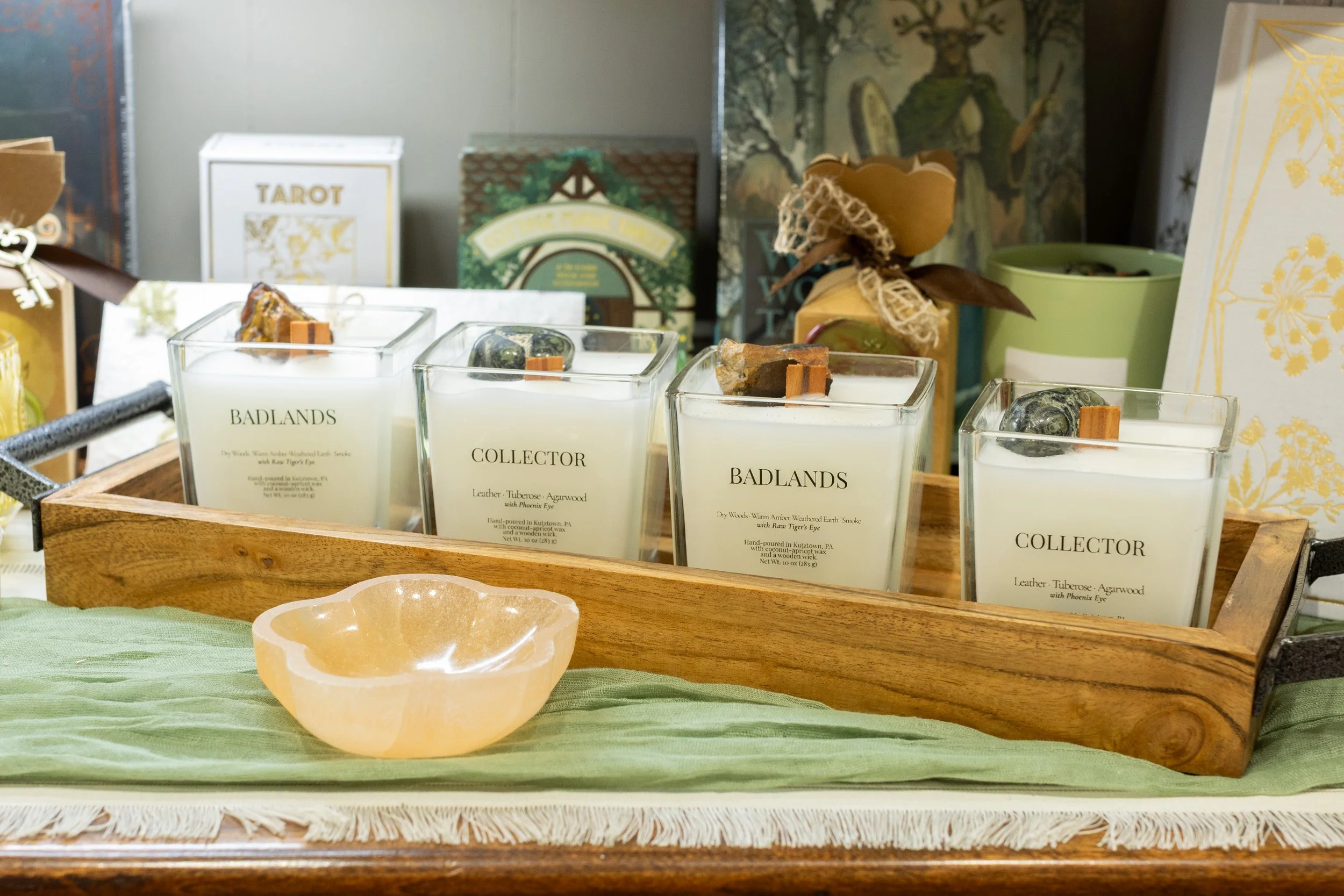 Crystal-topped candles displayed with tarot decks at Libra Rising in Skippack, Pennsylvania.