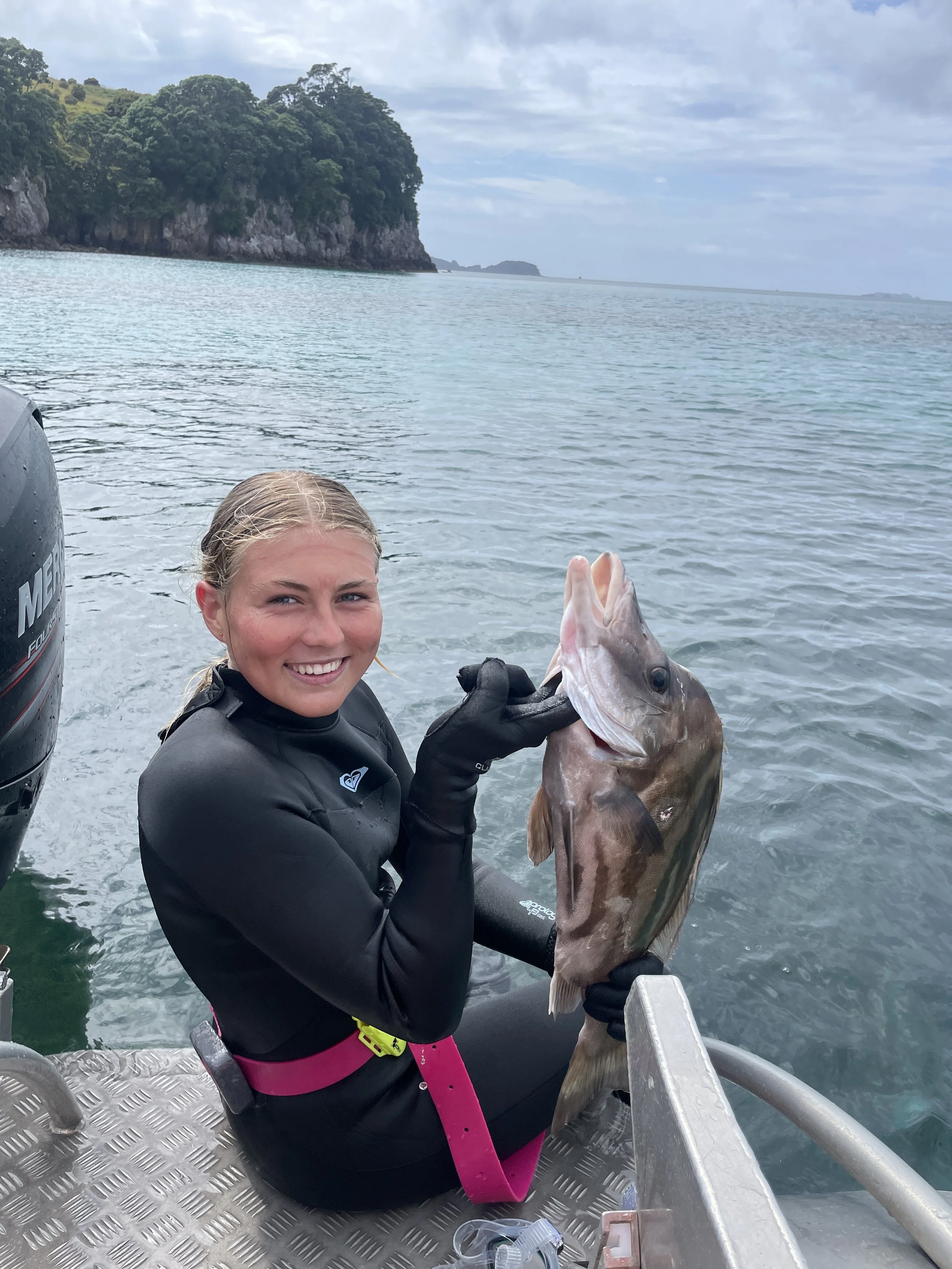 Guests holding fresh catch on private fishing charter in Whitianga, Coromandel
