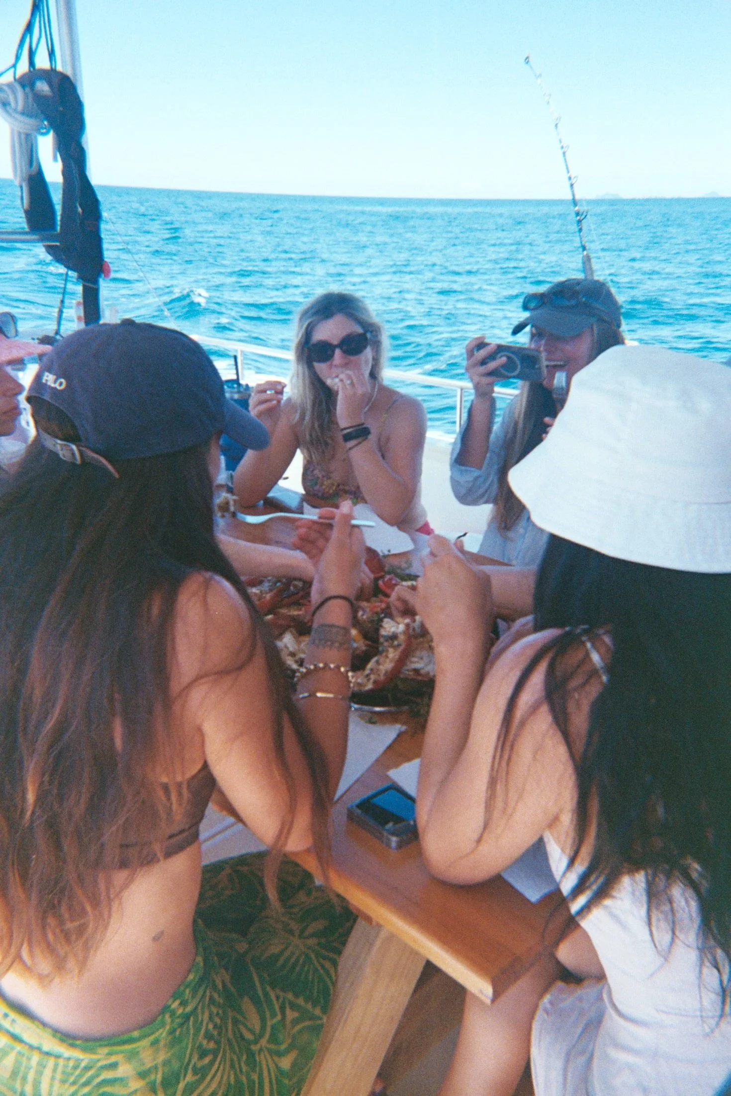 womens freedive group feasting on crayfish during guided seafood gathering experience in New Zealand