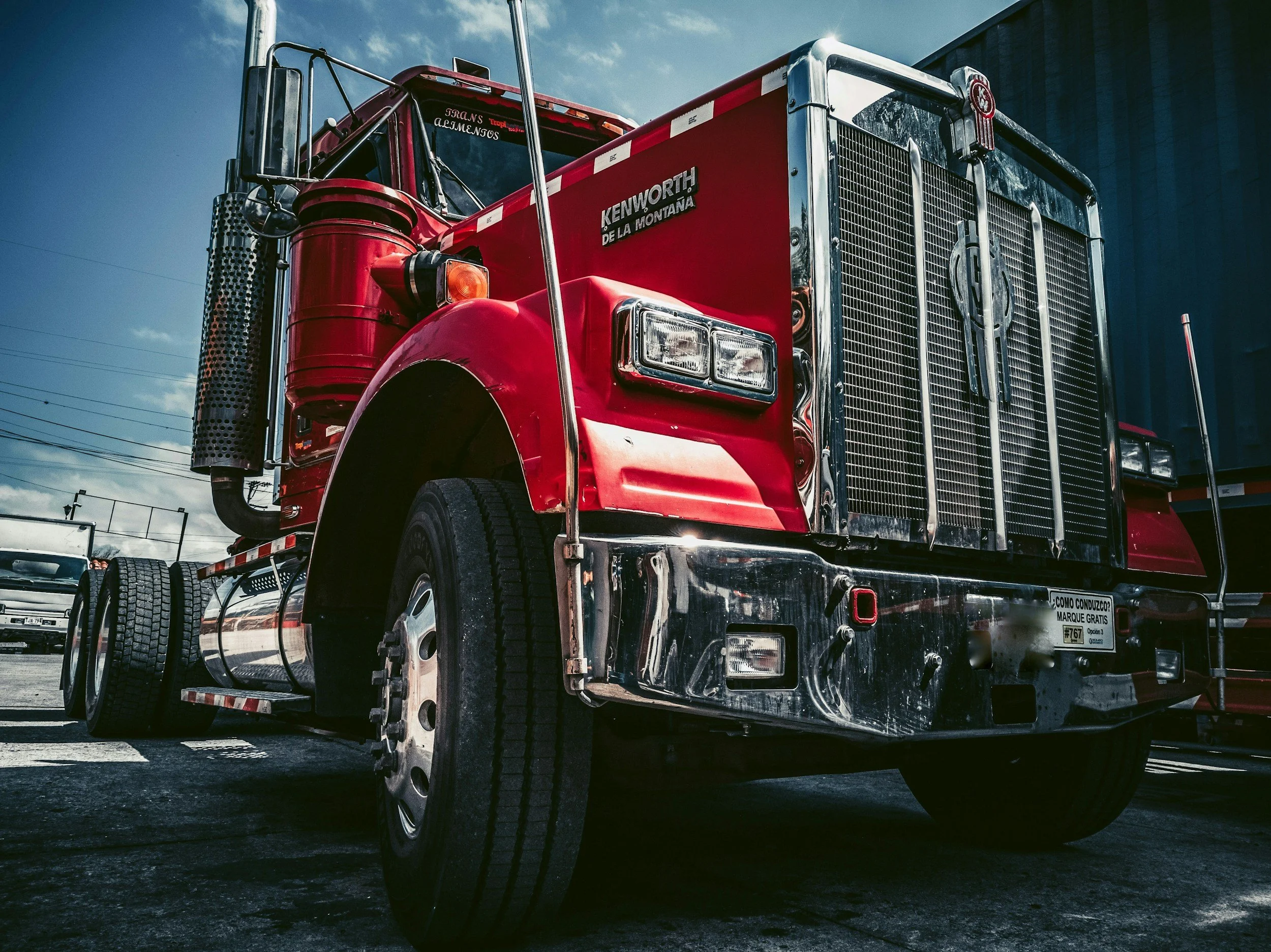 Heavy-duty truck brake service — technician inspecting air disc brake assembly on a diesel semi-truck