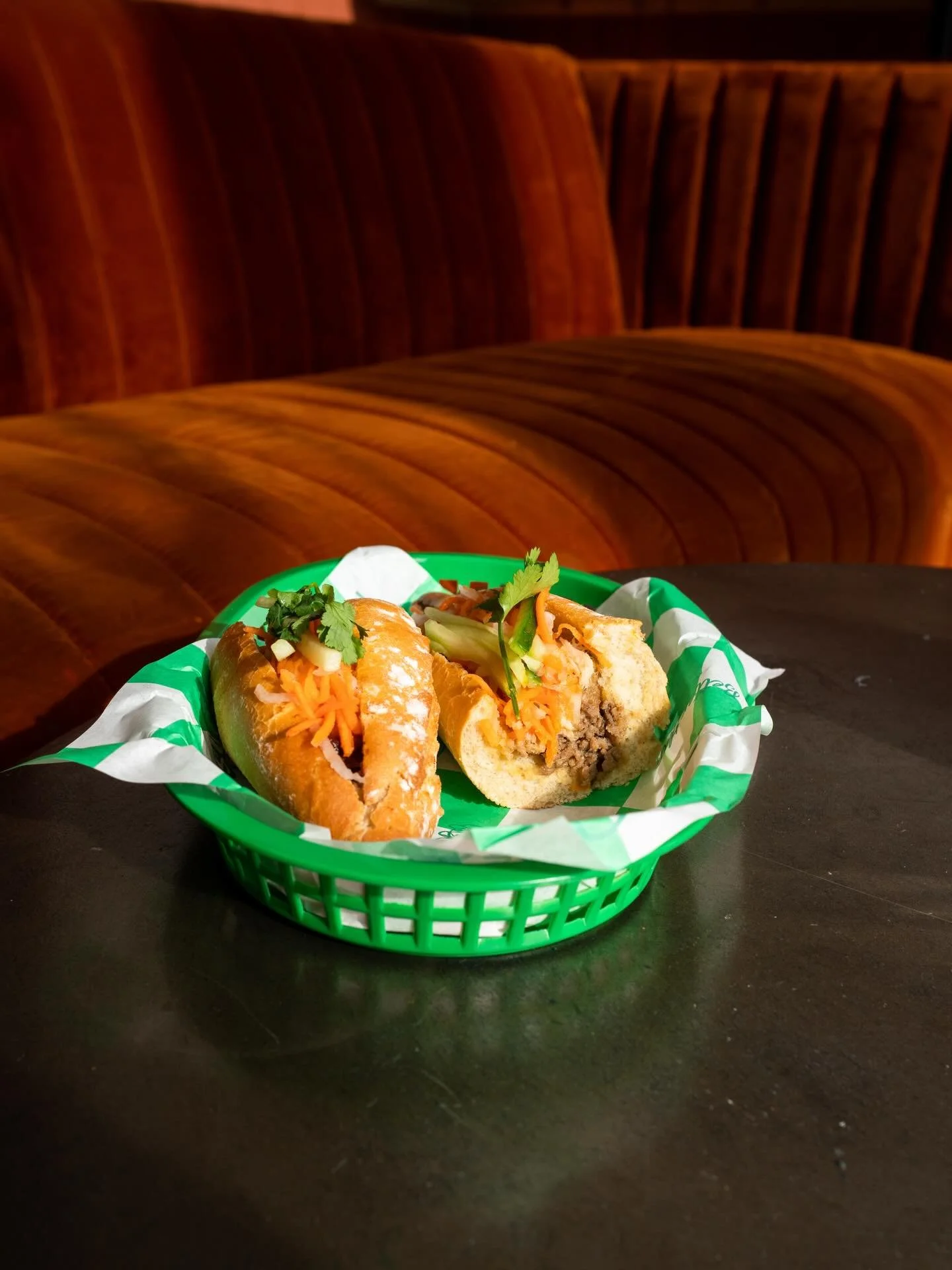 B&Aacute;NH M&Igrave;
Crusty French Baguette 
Vietnamese Spiced Pork Sausage
Sticky Lemongrass Pork Belly
Shredded Carrot, Daikon Radish + Cucumber
Black Garlic Aioli
Jalape&ntilde;o Vinaigrette 
Coriander