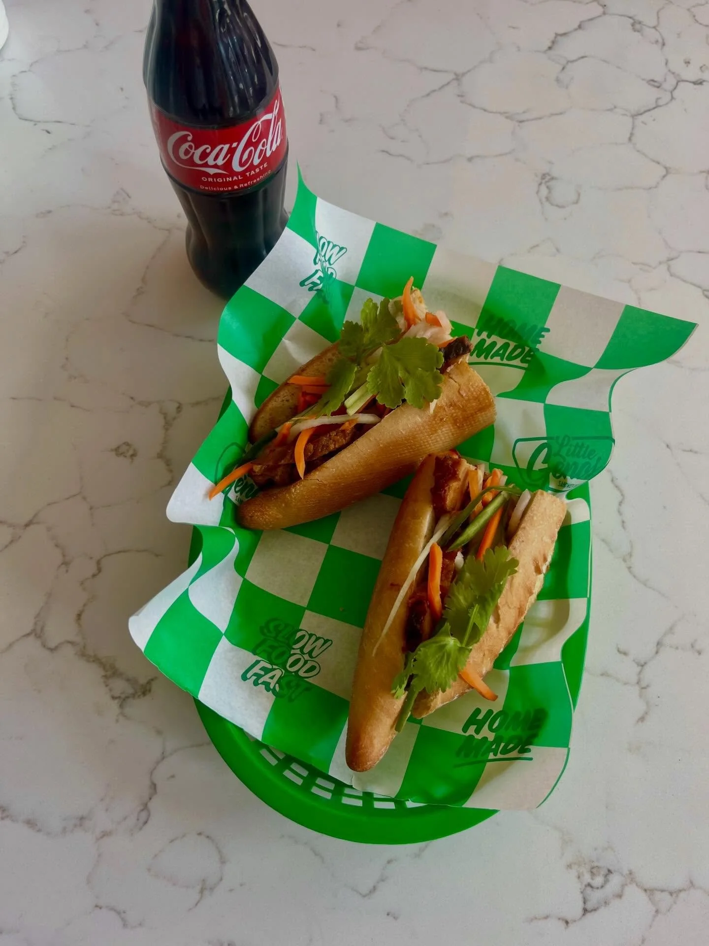 B&Aacute;NH M&Igrave;
Crusty French Baguette 
Vietnamese Spiced Pork Sausage
Sticky Lemongrass Pork Belly
Shredded Carrot, Daikon Radish + Cucumber
Black Garlic Aioli
Jalape&ntilde;o Vinaigrette 
Coriander