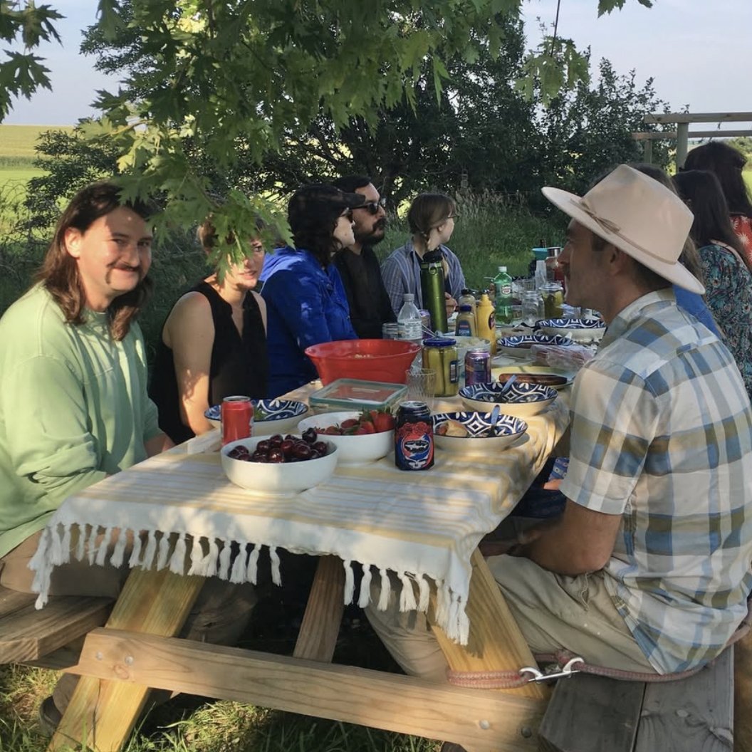 People eating at picnic tables.