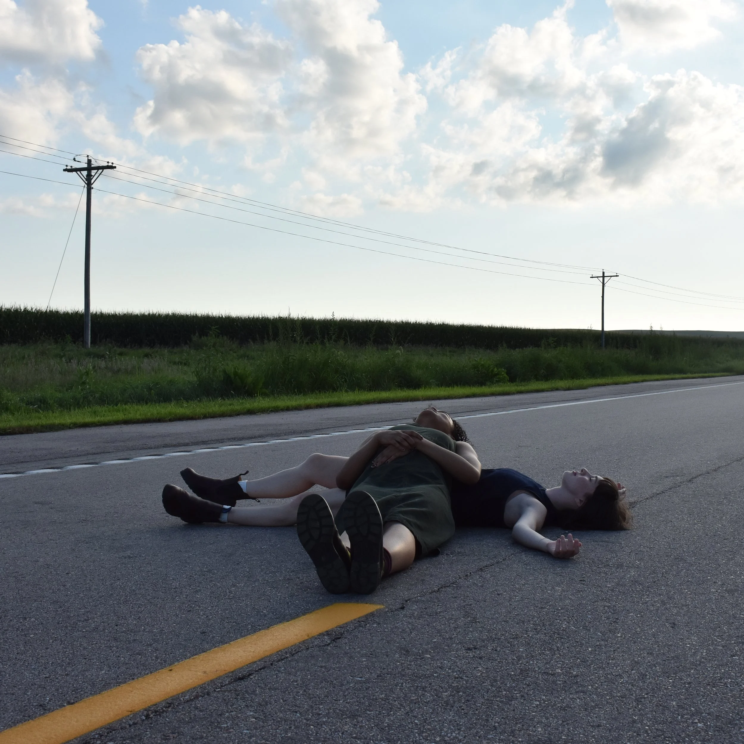 Woman lying on blacktop
