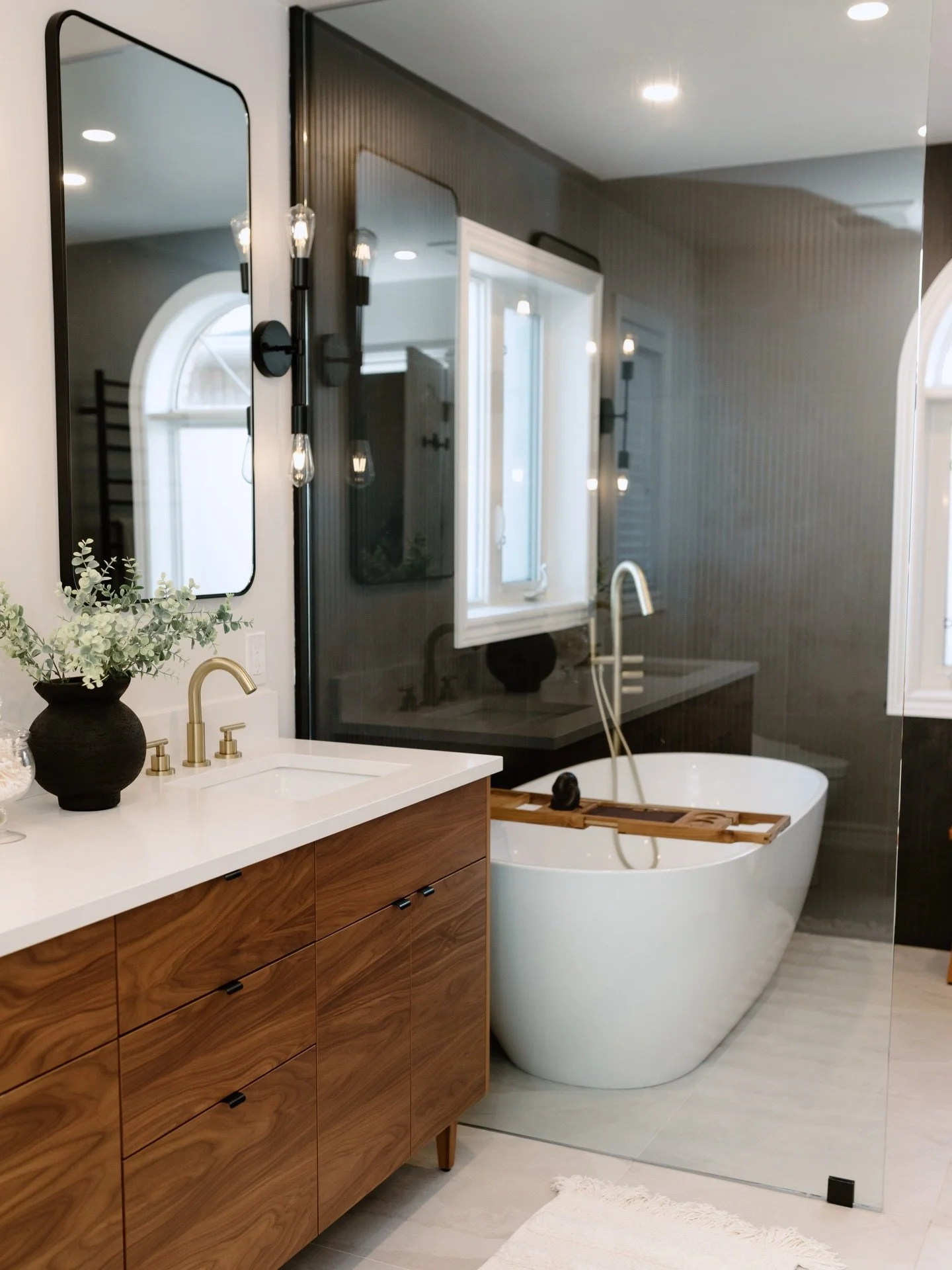 From blank slate to bold, moody, and beautiful ✨

This ensuite transformation will forever be one of our favourites.

Rich walnut tones, dramatic floor-to-ceiling black tile, warm brass fixtures, and the dreamiest freestanding tub moment. Every detai