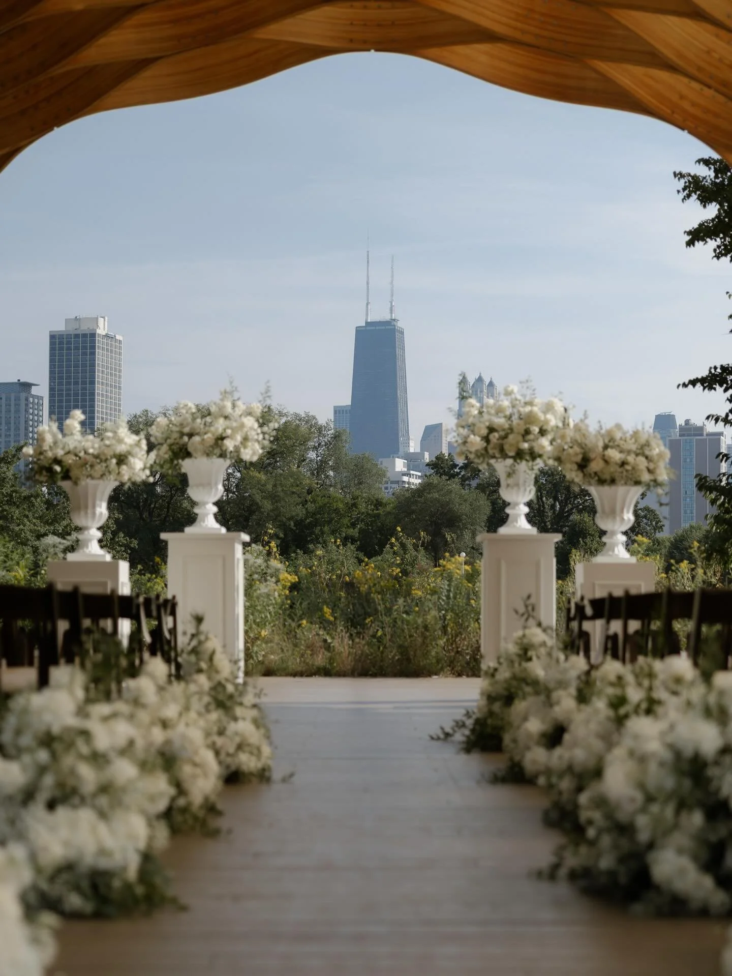 The Honeycomb perfectly balances city and nature. Its open geometric wooden form soars over guests, bringing a sense of intimacy to this open, natural space, framing the drama of the cityscape beyond.

Guests walking through the hum of bees and swayi