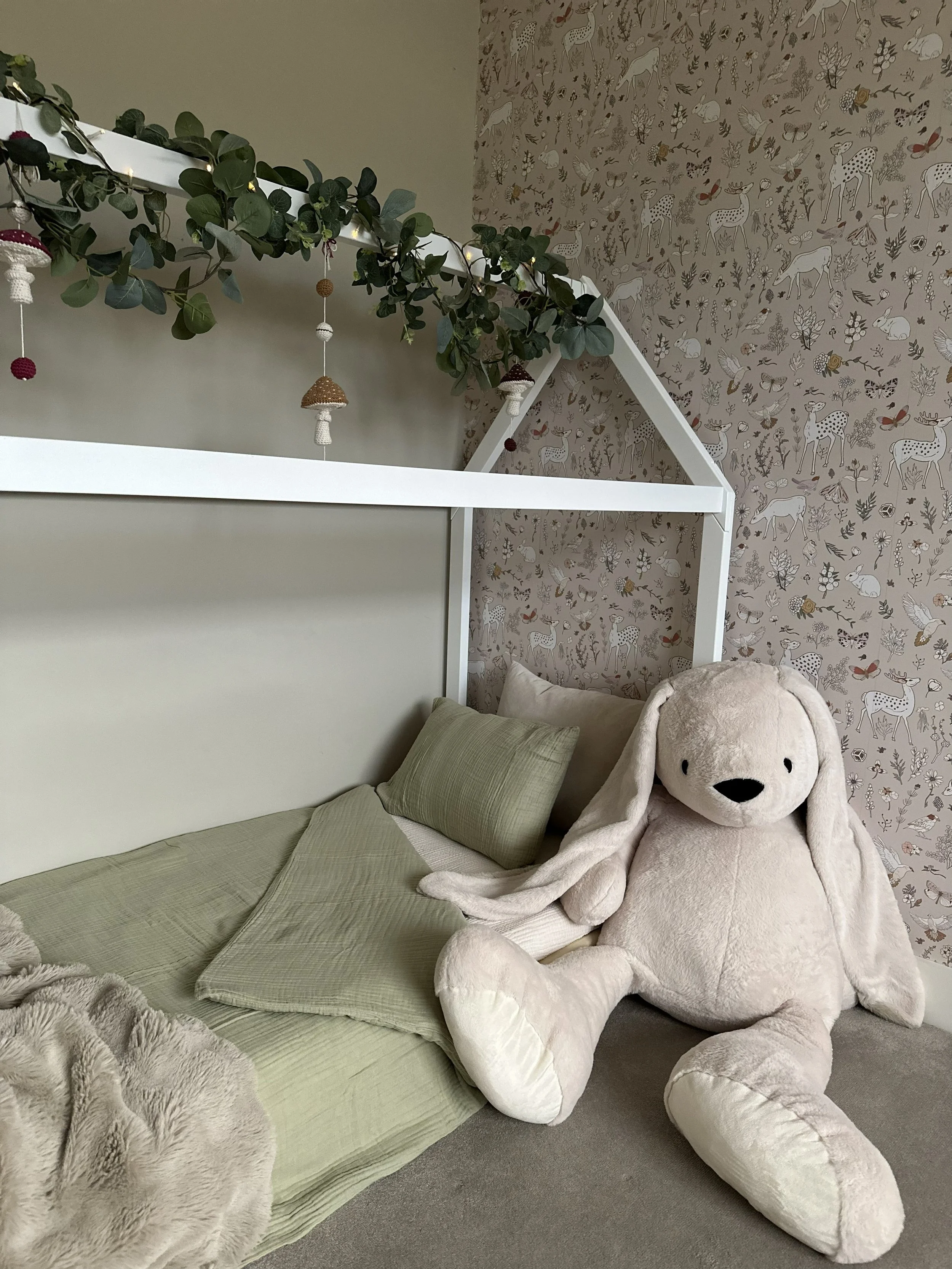 Montessori-inspired baby bed designed to support independence and comfort with soft neutral tones and natural materials.