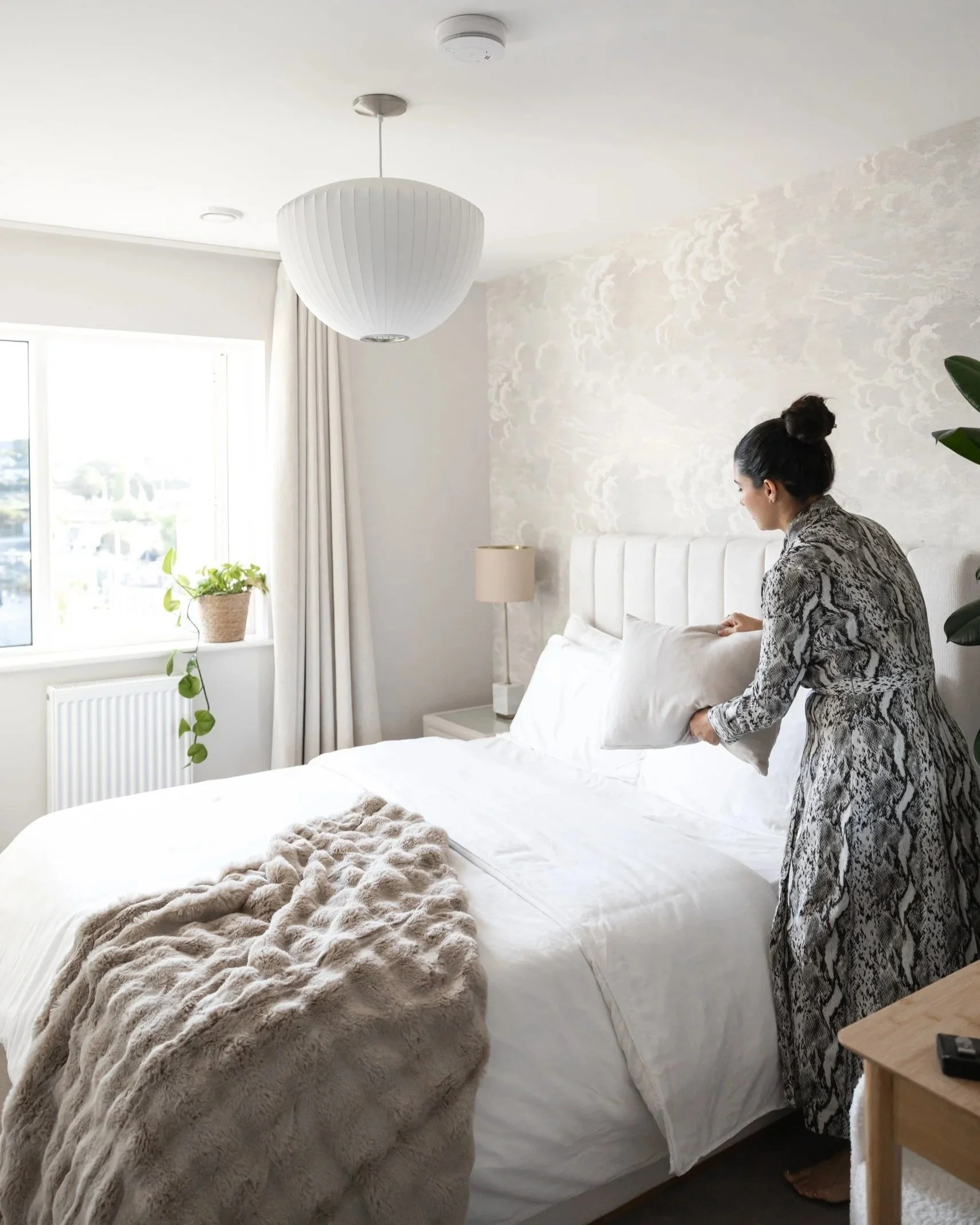 Professional home stager styling a bedroom to enhance comfort, balance and emotional connection.