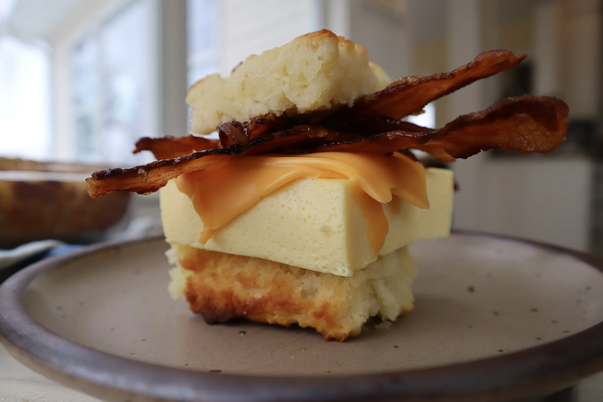 Butter Swim Biscuit Breakfast Sandwich with Candied Bacon and Fluffy Egg Slices