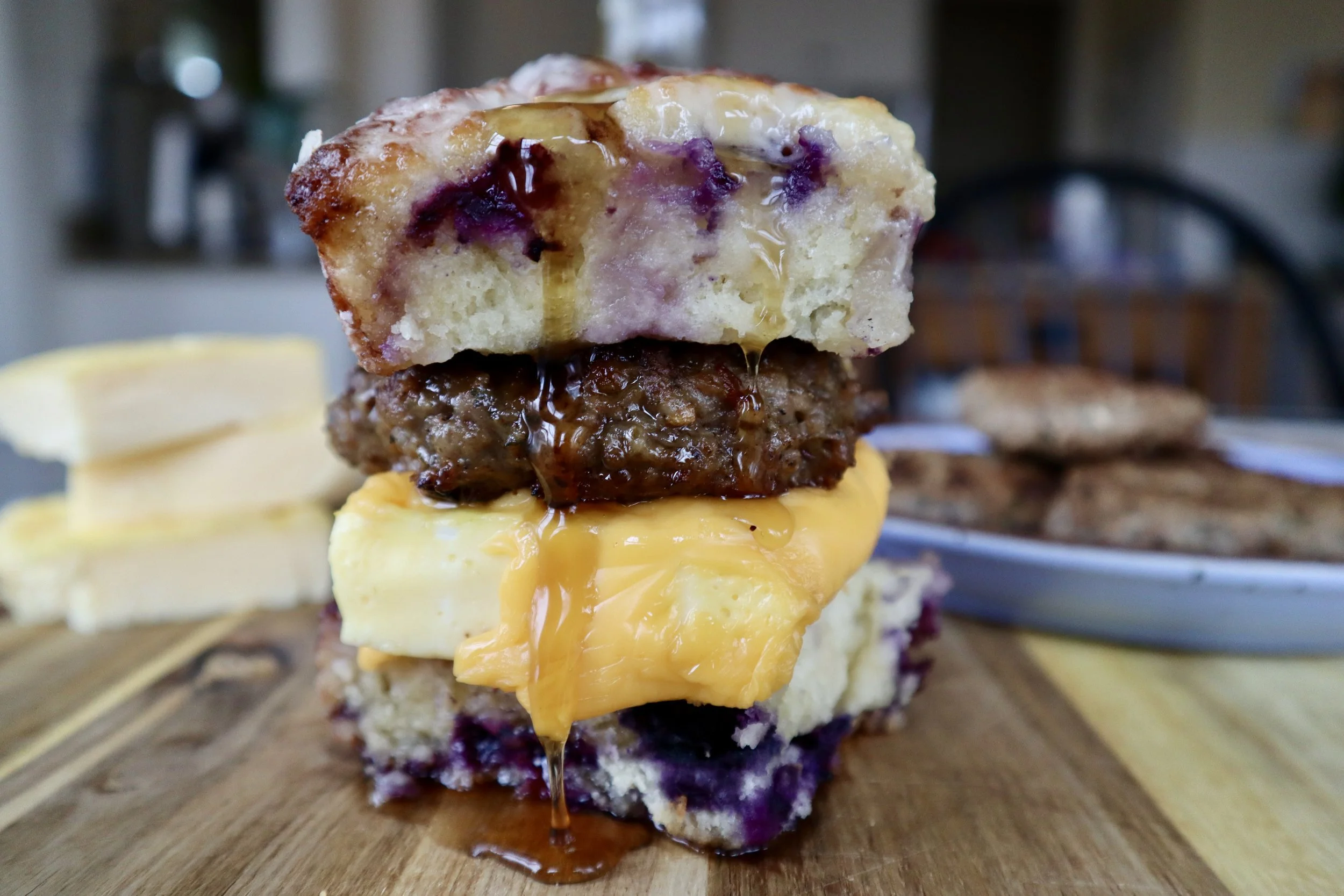Blueberry Butter Swim Biscuit Breakfast Sandwich with Sausage and Fluffy Egg Squares