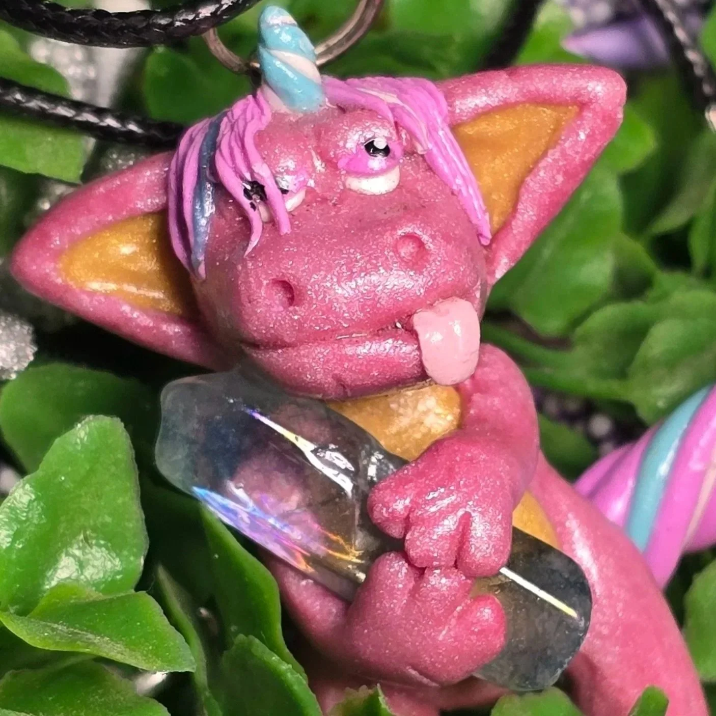 Krystal the Quartz Derpicorn - a pearlescent pink derpicorn with a gold belly and inner ears, with a tail and mane of candy pink, blue and white.