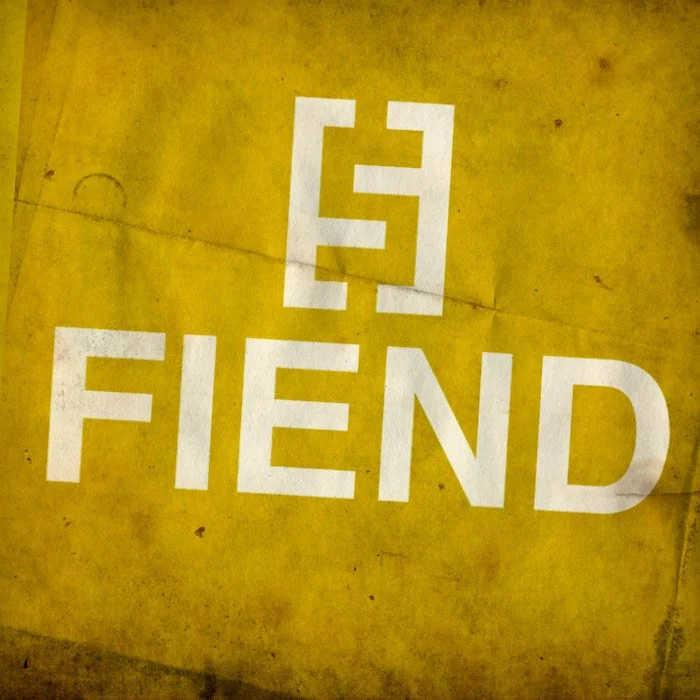 White painted symbol and the word 'FIEND' on a yellow surface.