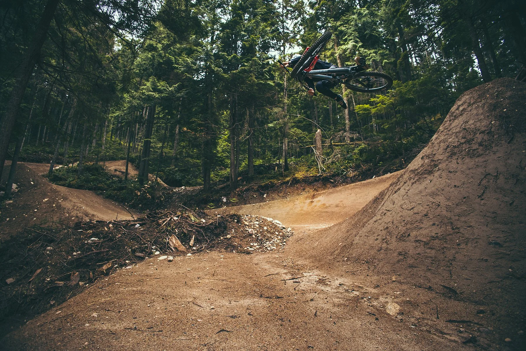 Person jumping over mud on bike