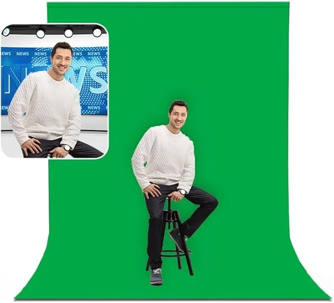 A man wearing a white sweater and black pants sitting on a stool in front of a green screen, with a mobile phone overlay showing the same man in a news studio background.