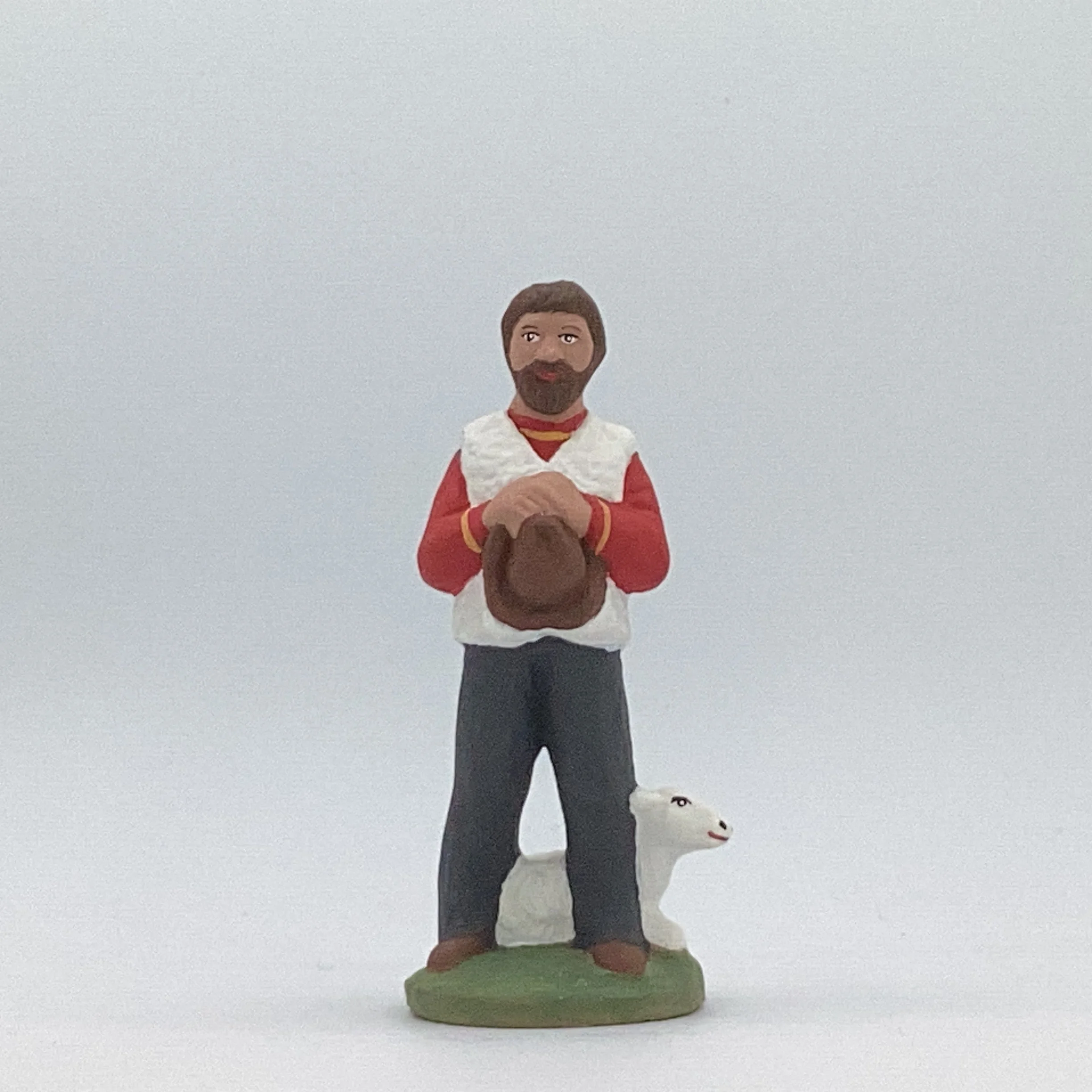 Berger avec un mouton à ses pieds