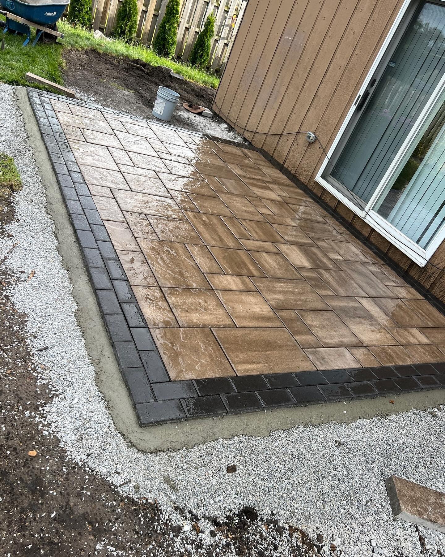 Paver patio with pea-gravel/stepping stone walkway complete! We used Oakwood Unilock Beacon Hill for the patio wrapped in a Charcoal Hollandstone soldier course. Contact us for your outdoor living projects! 708-527-1707