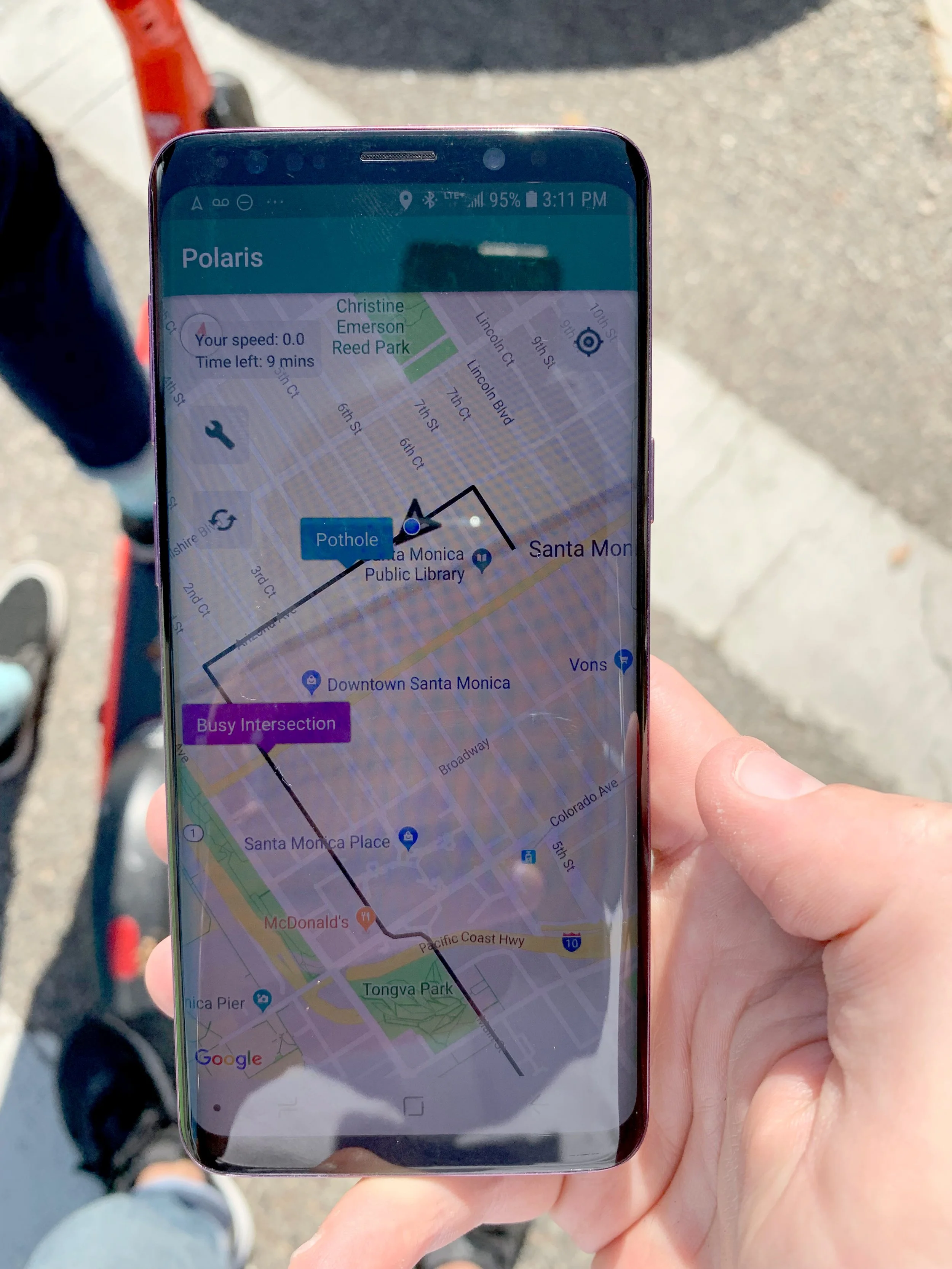 Smartphone with a navigation app highlighting hazards and routes