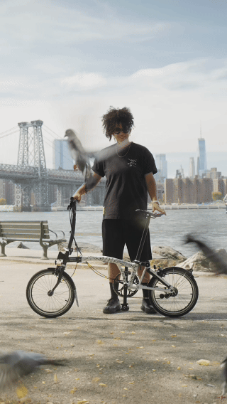 Artist Shantell Martin riding a bike through NYC