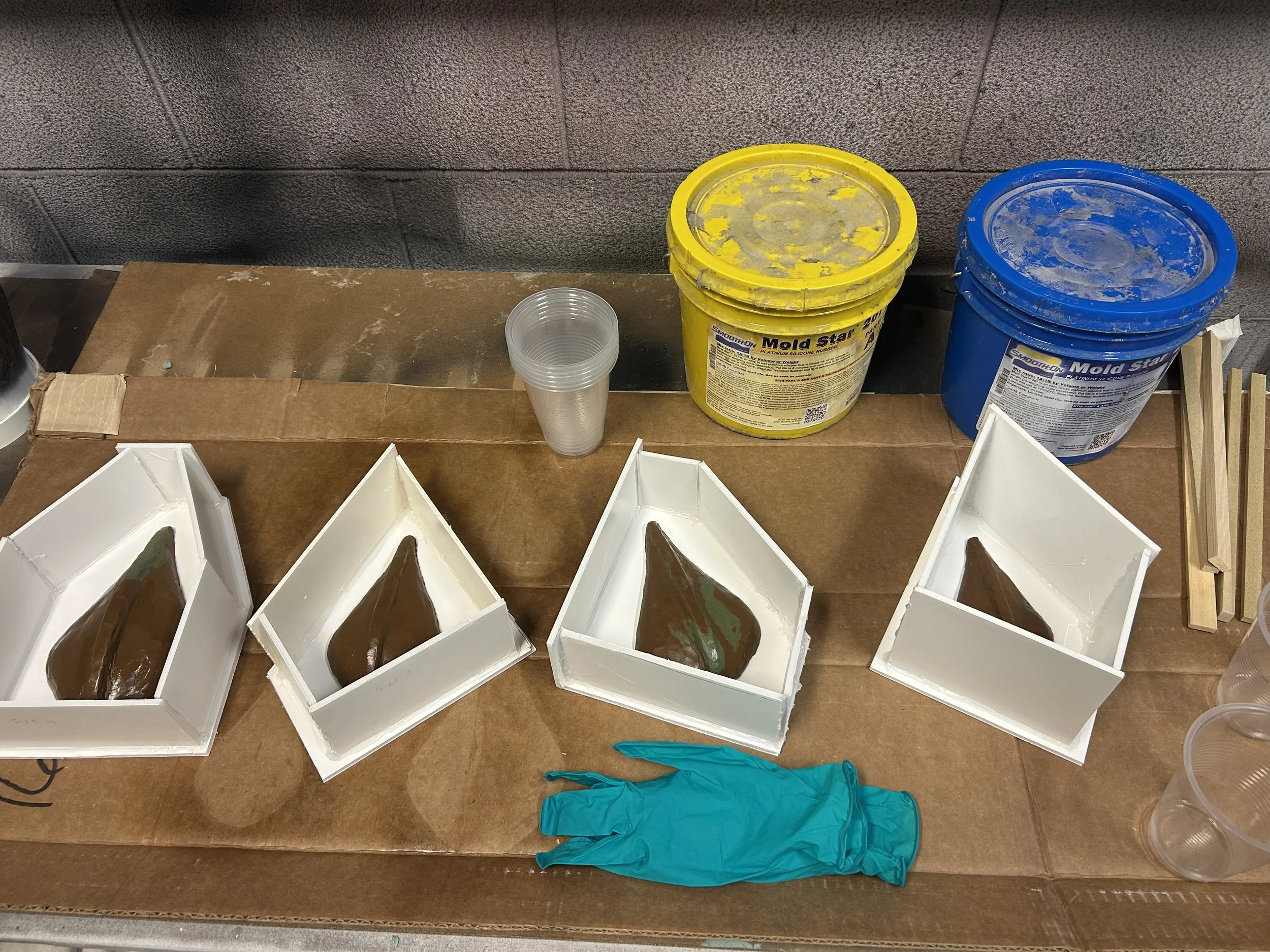 molds for clay dragon scales (final scales  made using the resulting plaster scales to vacuform plastic covered in color shift car vinyl)