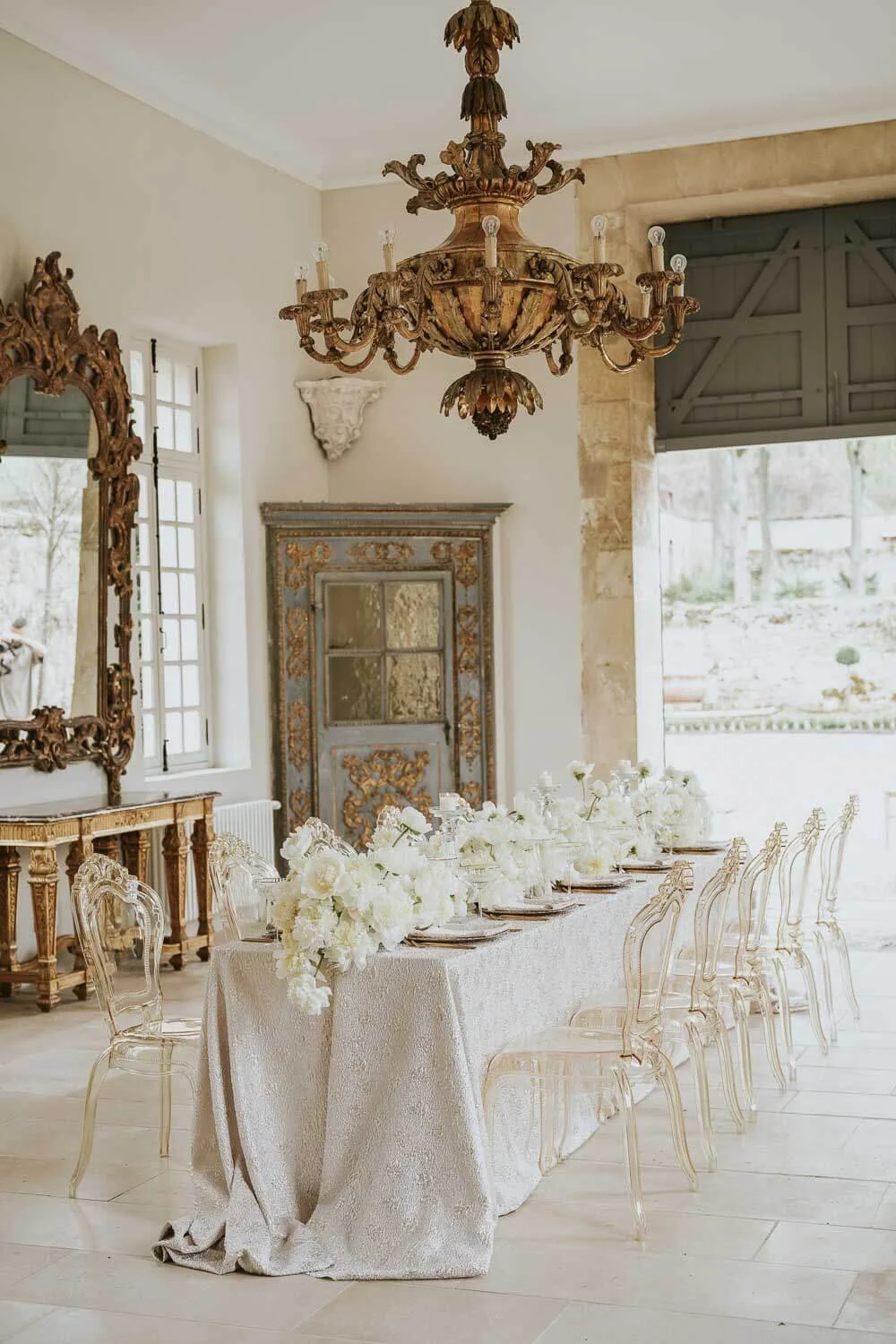 elegant simple wedding table decorations long table ivory neutral palette ghost chairs refined floral styling de Waay