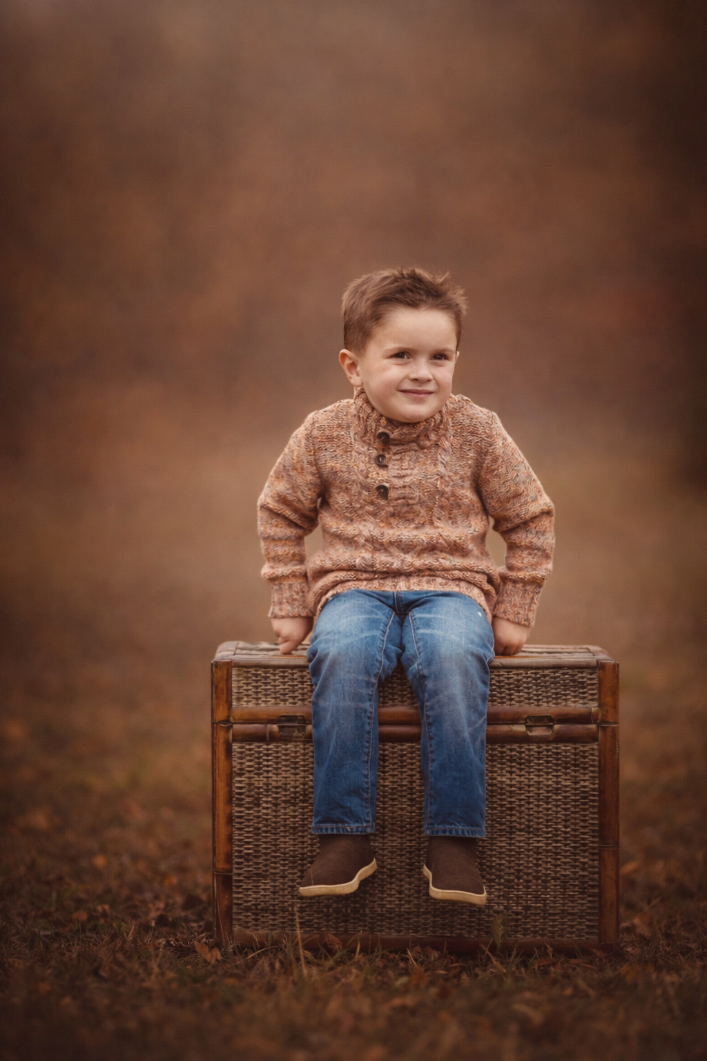 Toddler smiling while standing on a wooden box during a Philadelphia portrait session