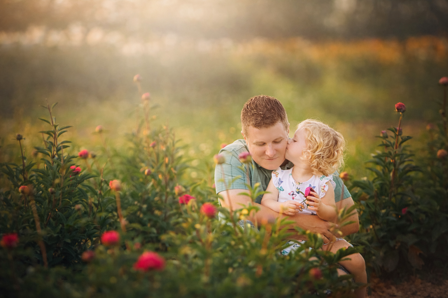 Father and daughter during a South Jersey family portrait session, daughter kissing her dad on the cheek.