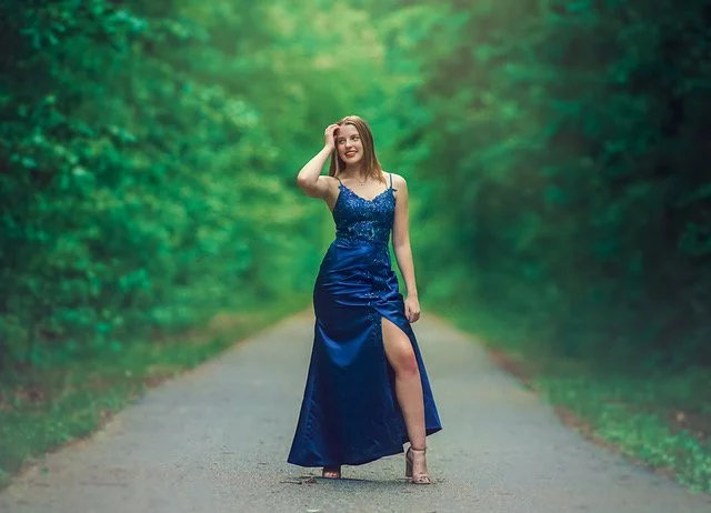 Teen portrait in a blue prom dress photographed in a South Jersey forest during an outdoor fine art session.