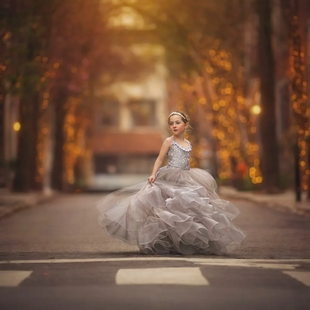 Young girl in a silver dress on Addison Street near Rittenhouse Square in Philadelphia during a child portrait session.