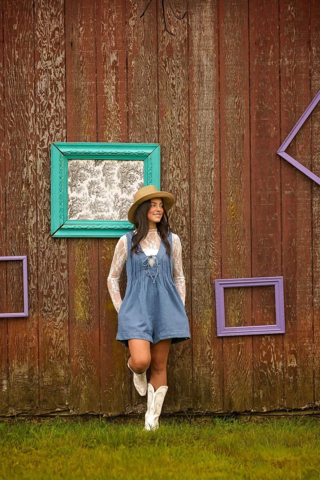 Teen girl posing against a rustic wooden wall during a senior portrait session near Philadelphia and South Jersey.
