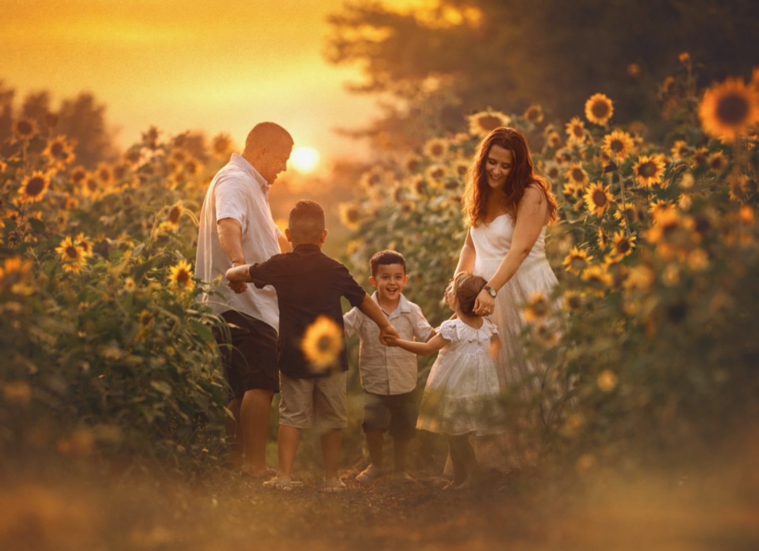A South Jersey family enjoying a warm sunset portrait session together in a wildflower field photographed in a natural fine art style