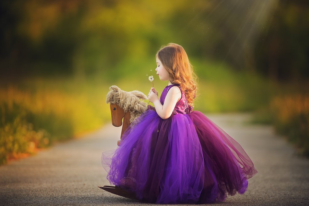toddler blowing dandelion during outdoor portrait session in Sewell NJ