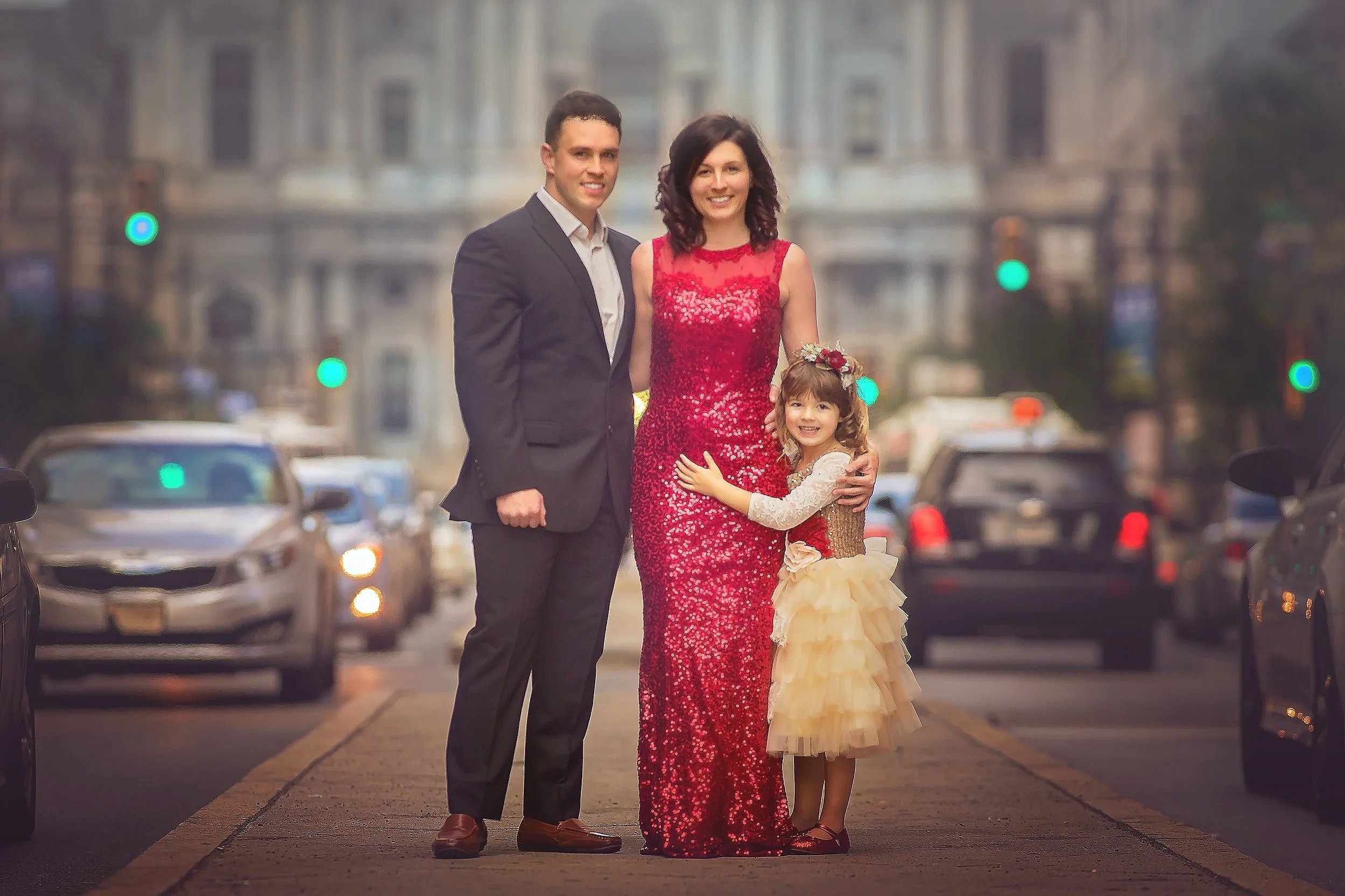Family portrait walking in front of Philadelphia City Hall photographed by a Philadelphia family photographer