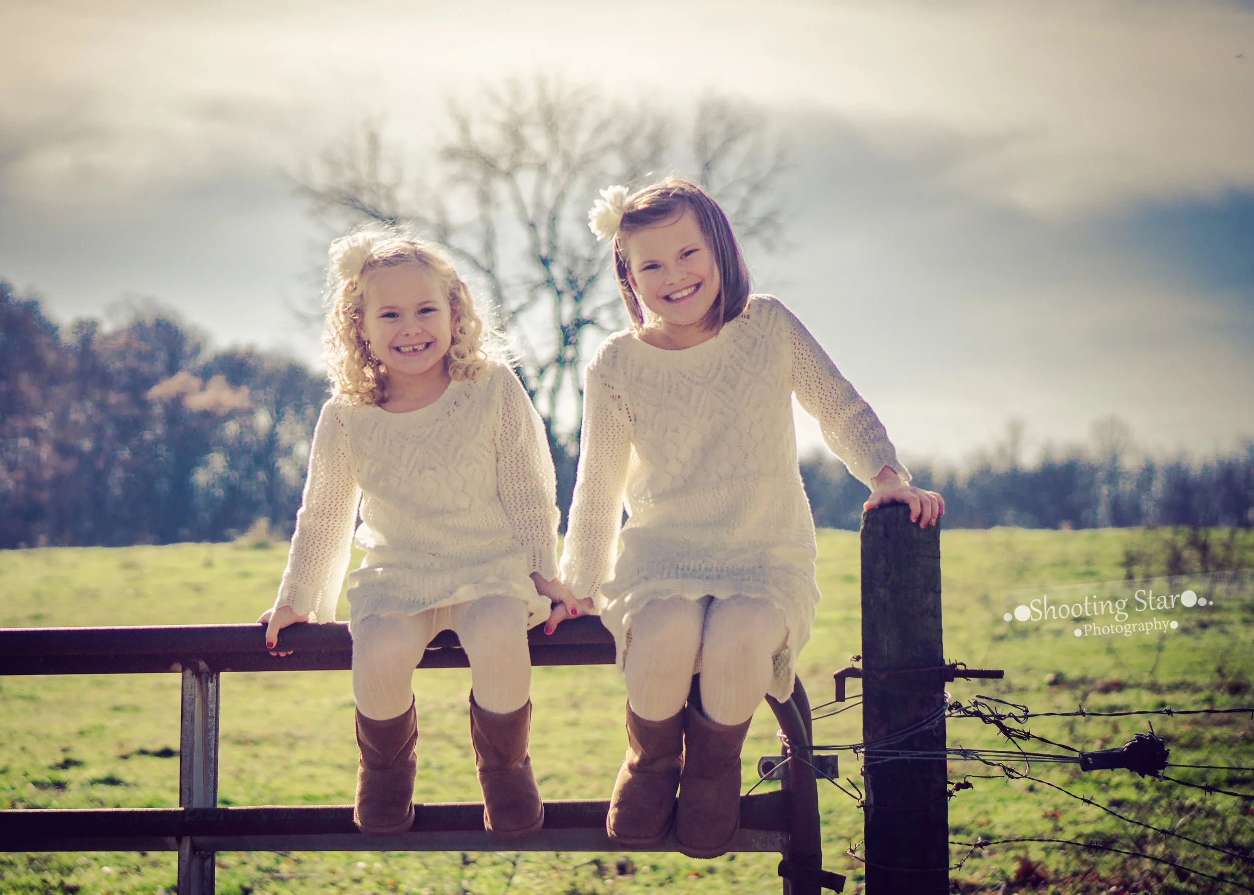 Girls sitting together on a fence at Daretown Lake in Elmer, New Jersey.