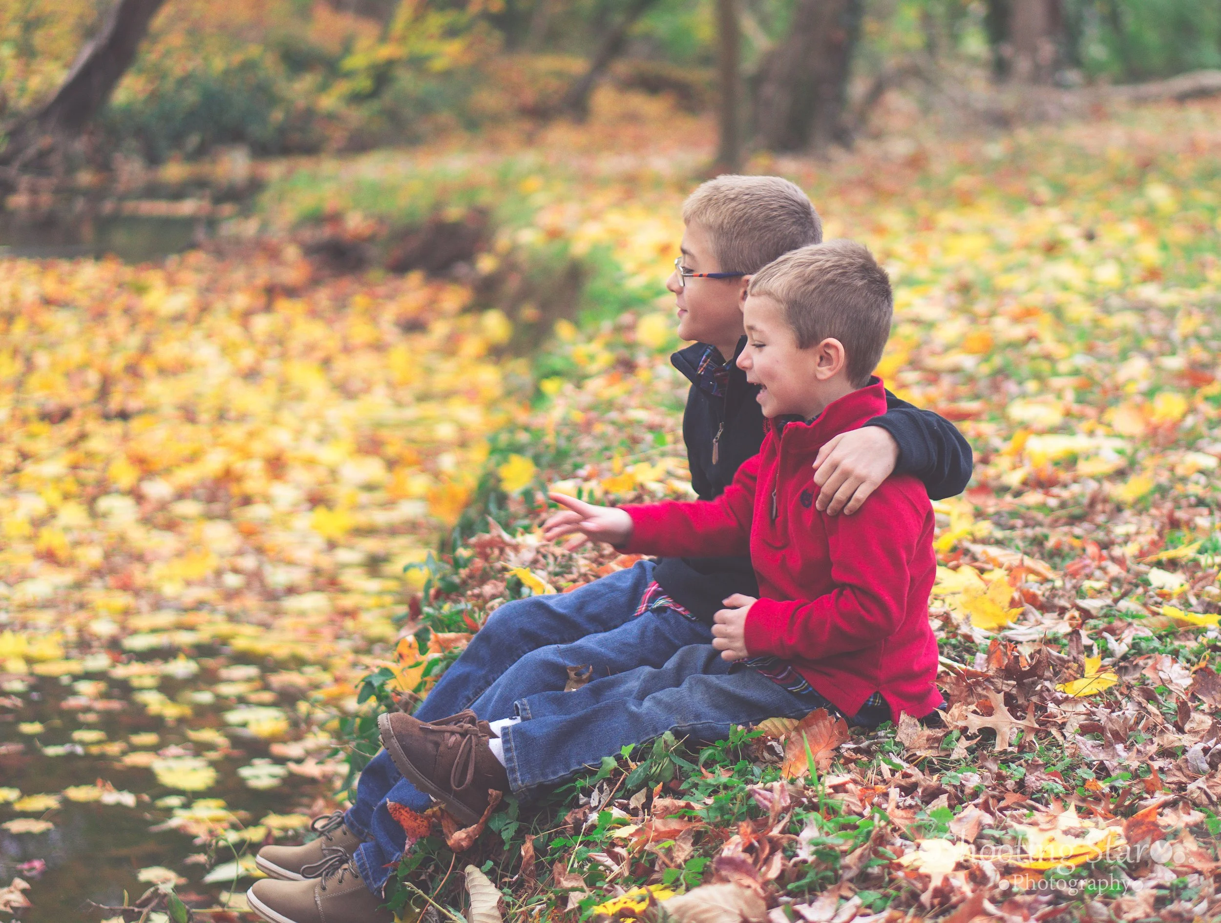 Brothers sitting together near a stream in Salem County, New Jersey.