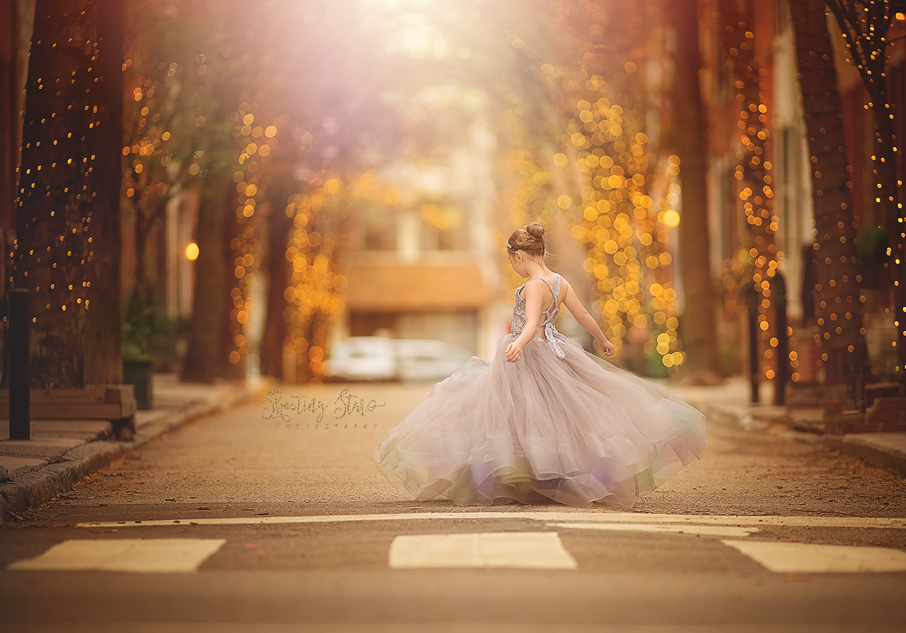 Girl twirling in a beautiful dress during a fine art portrait session on Addison Street.