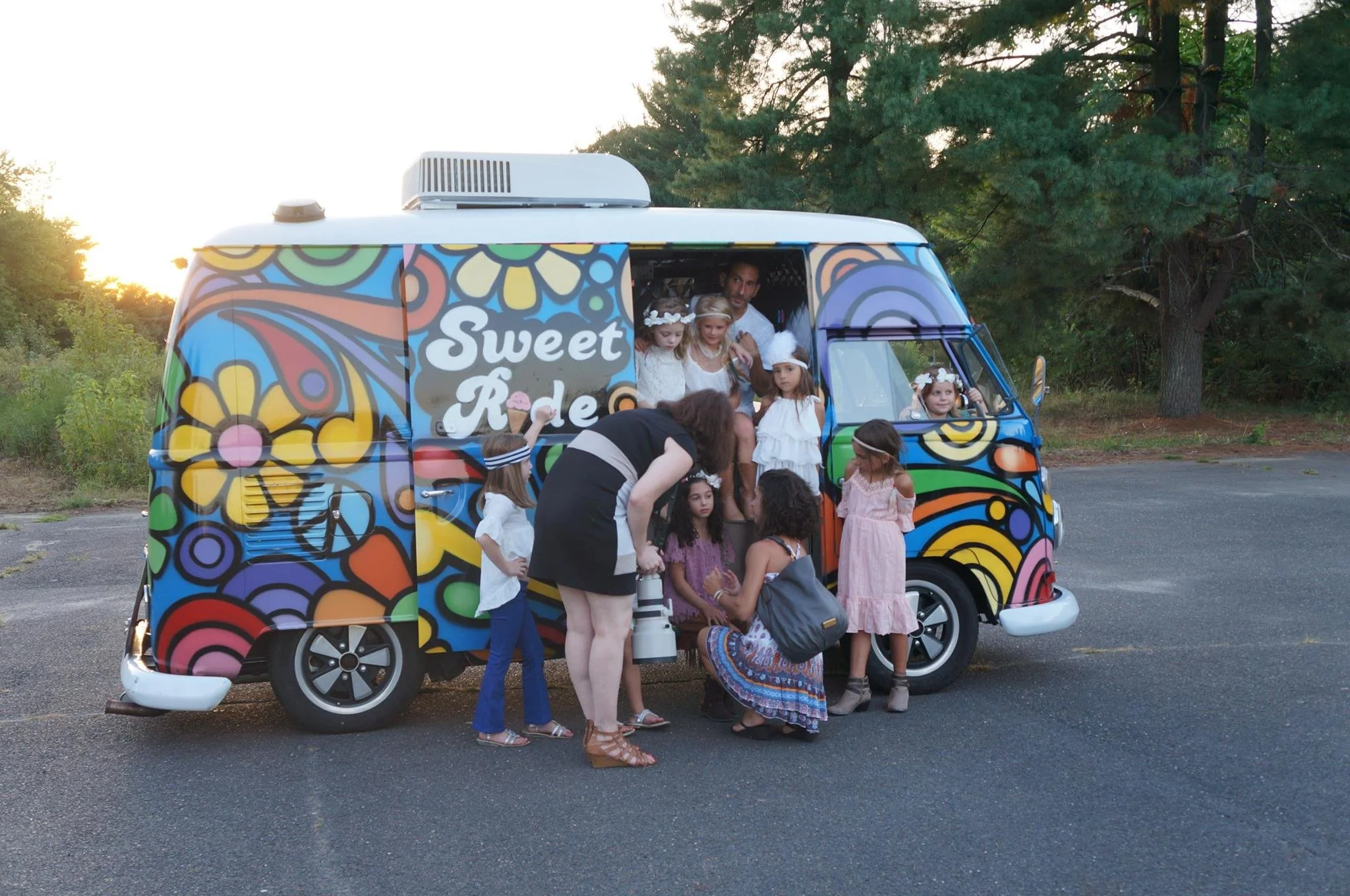 Behind-the-scenes view of a family photographer talking with children to create a relaxed and playful portrait session in South Jersey