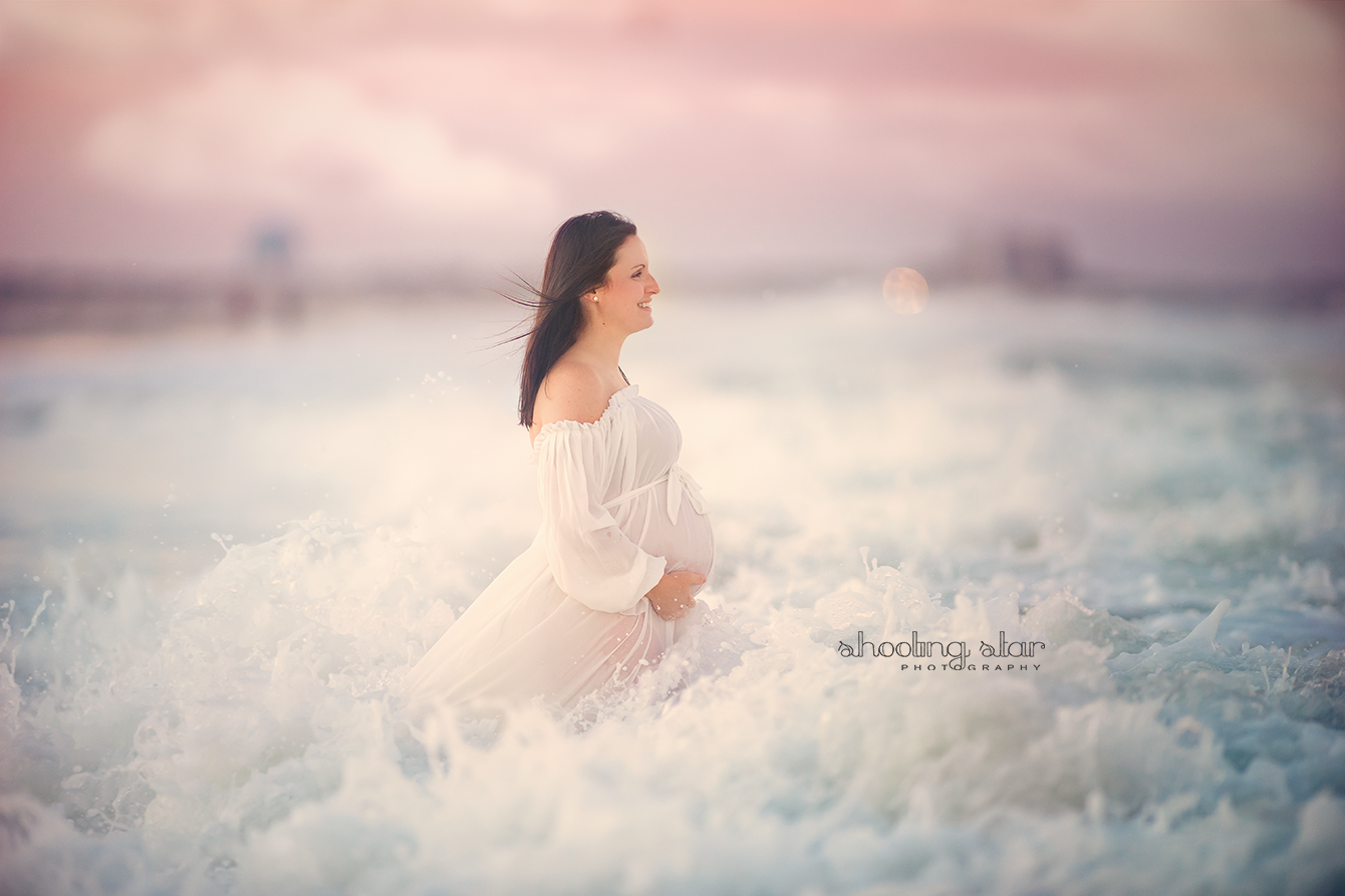 beautiful portrait of mom in white in the water at the Jersey Shore for her maternity portraits by South Jersey photographer Shooting Star Photography