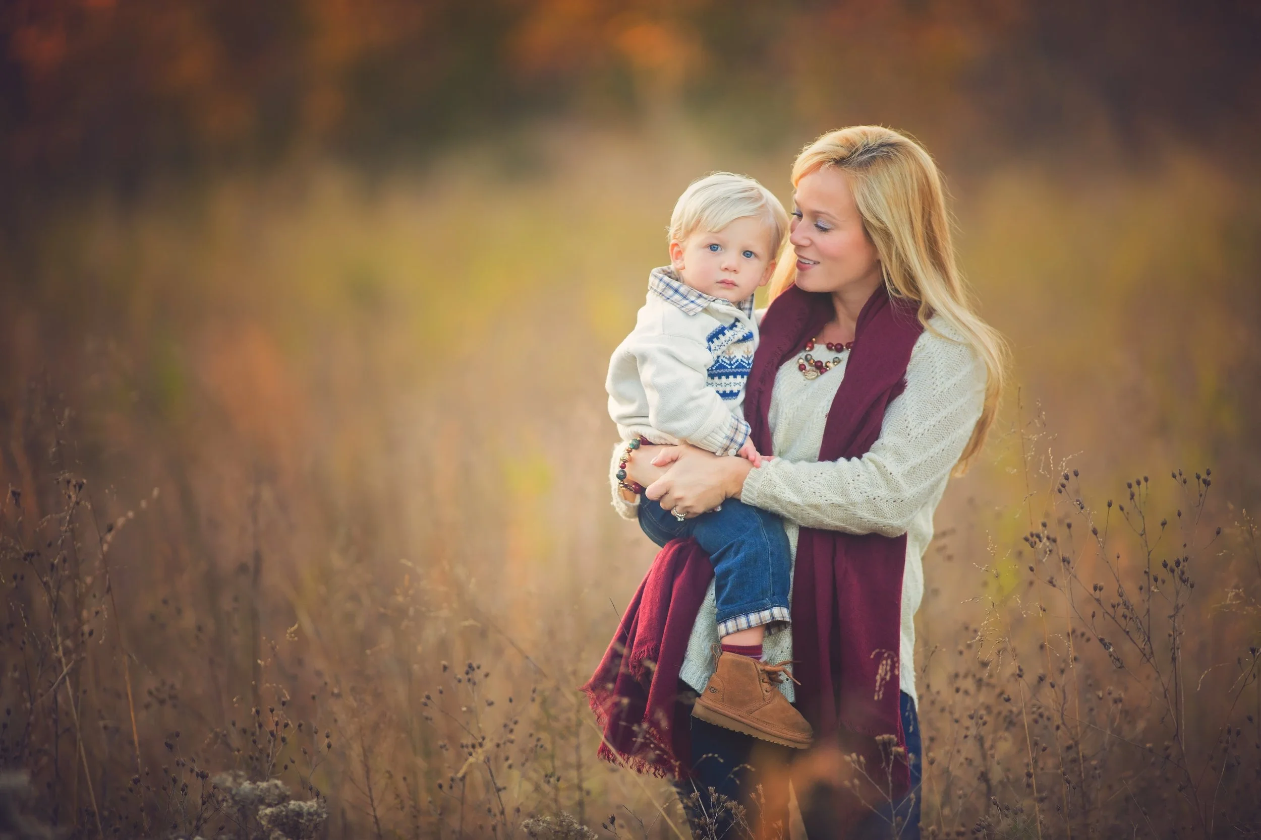 Mom holding her toddler in soft natural light during a family portrait session near Lake Audrey in Millville NJ.
