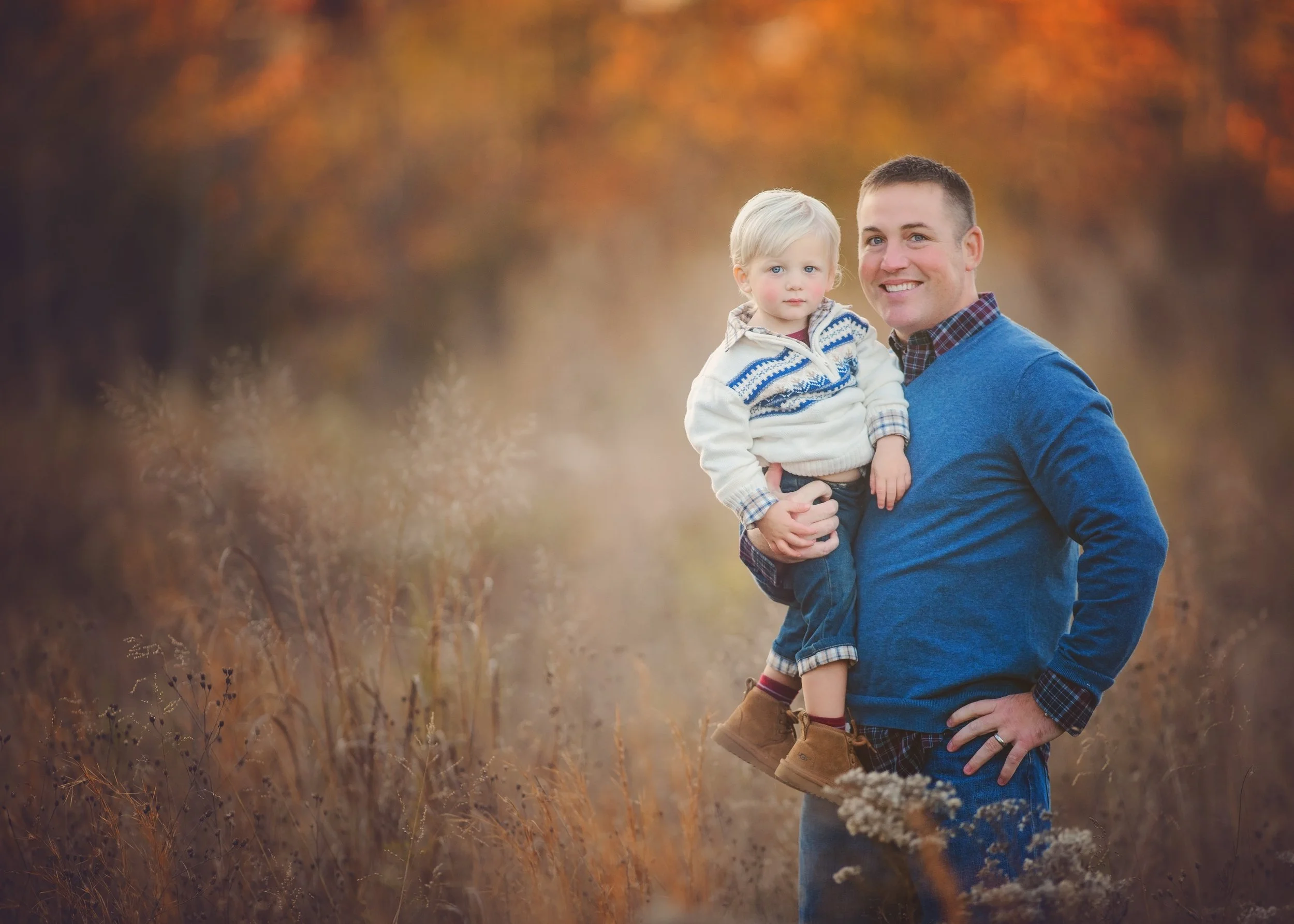Dad holding his young son during a family photography session in Millville New Jersey captured by a South Jersey family photographer.