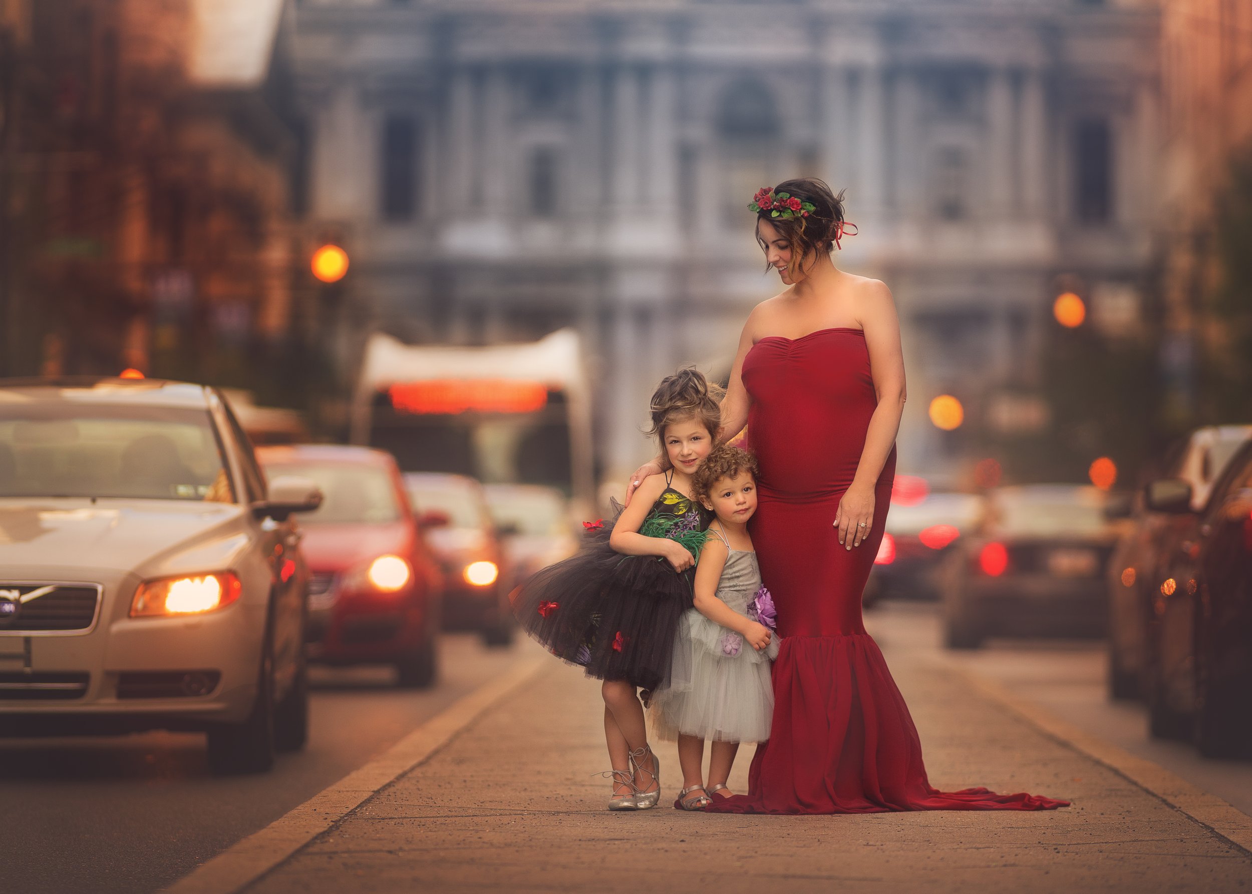 Expectant mother with her two daughters during maternity portrait session on Broad Street in Philadelphia