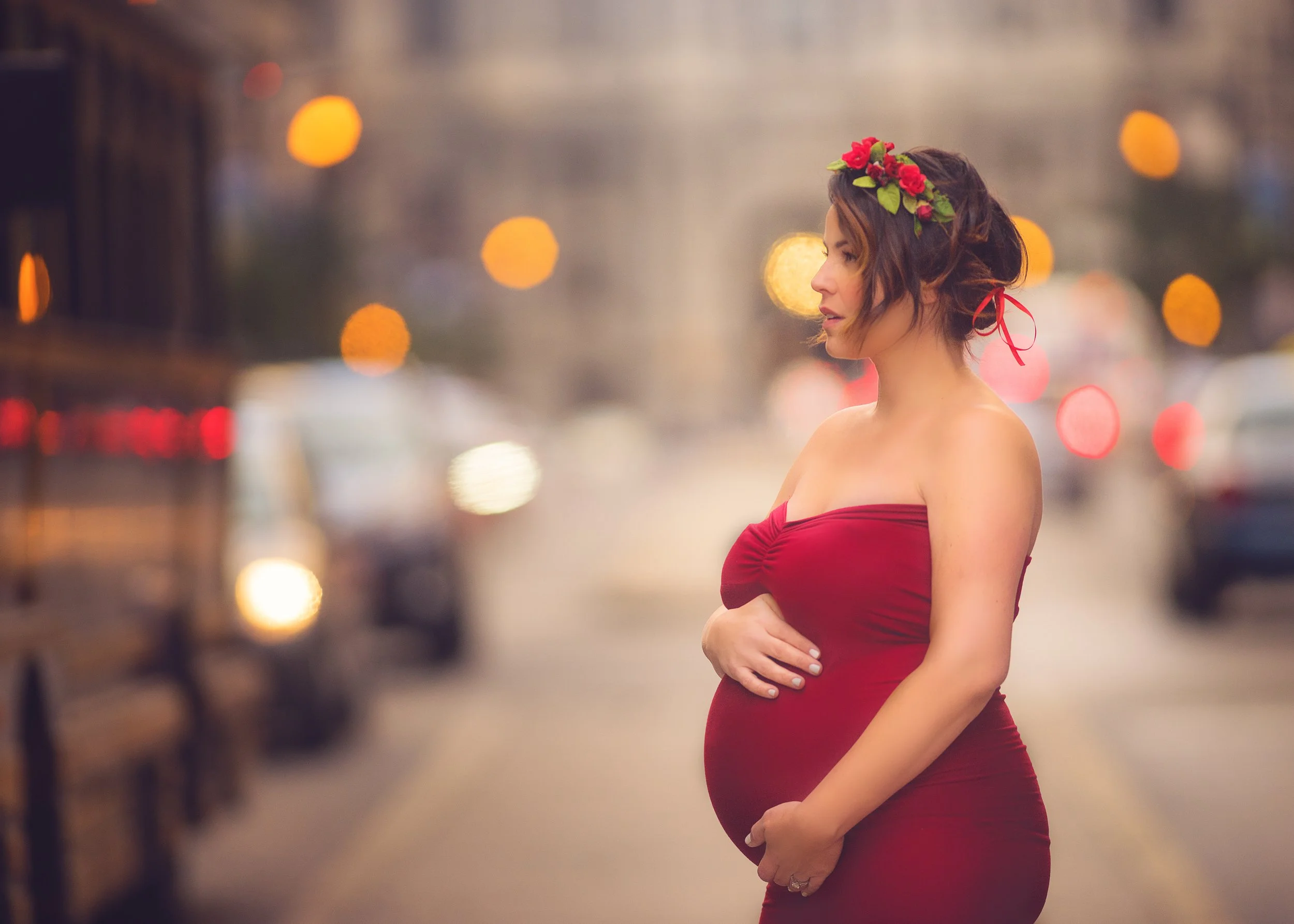 Profile maternity portrait of expectant mother in red gown photographed in Philadelphia