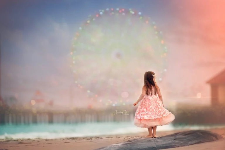 Girl looking out at the Atlantic City Ferris wheel at sunset during a fine art portrait session