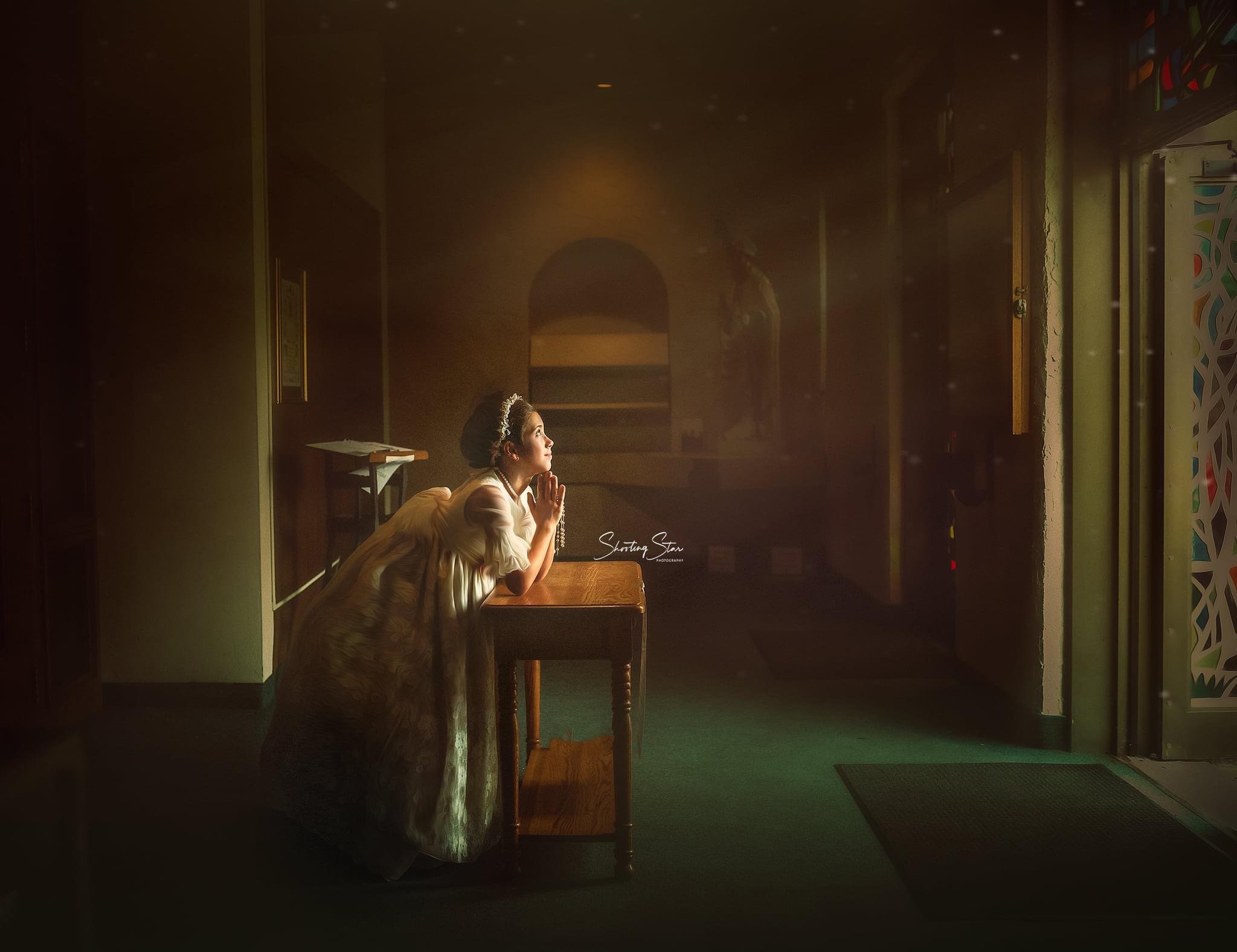First Holy Communion portrait of a young girl standing in a church foyer in Ocean City, New Jersey, softly lit by natural window light