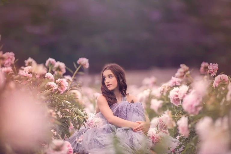Girl sitting in field during South Jersey natural light portrait session