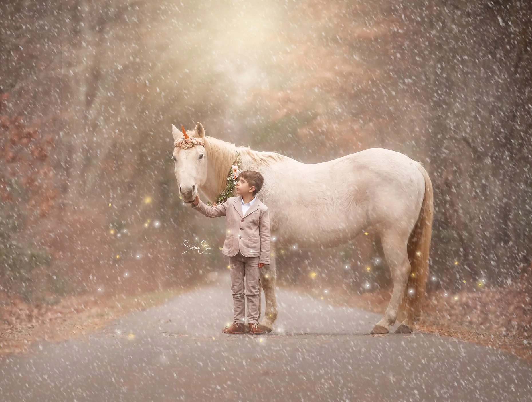 A young boy sharing a quiet, reflective moment with Drifter the unicorn during a magical portrait session.