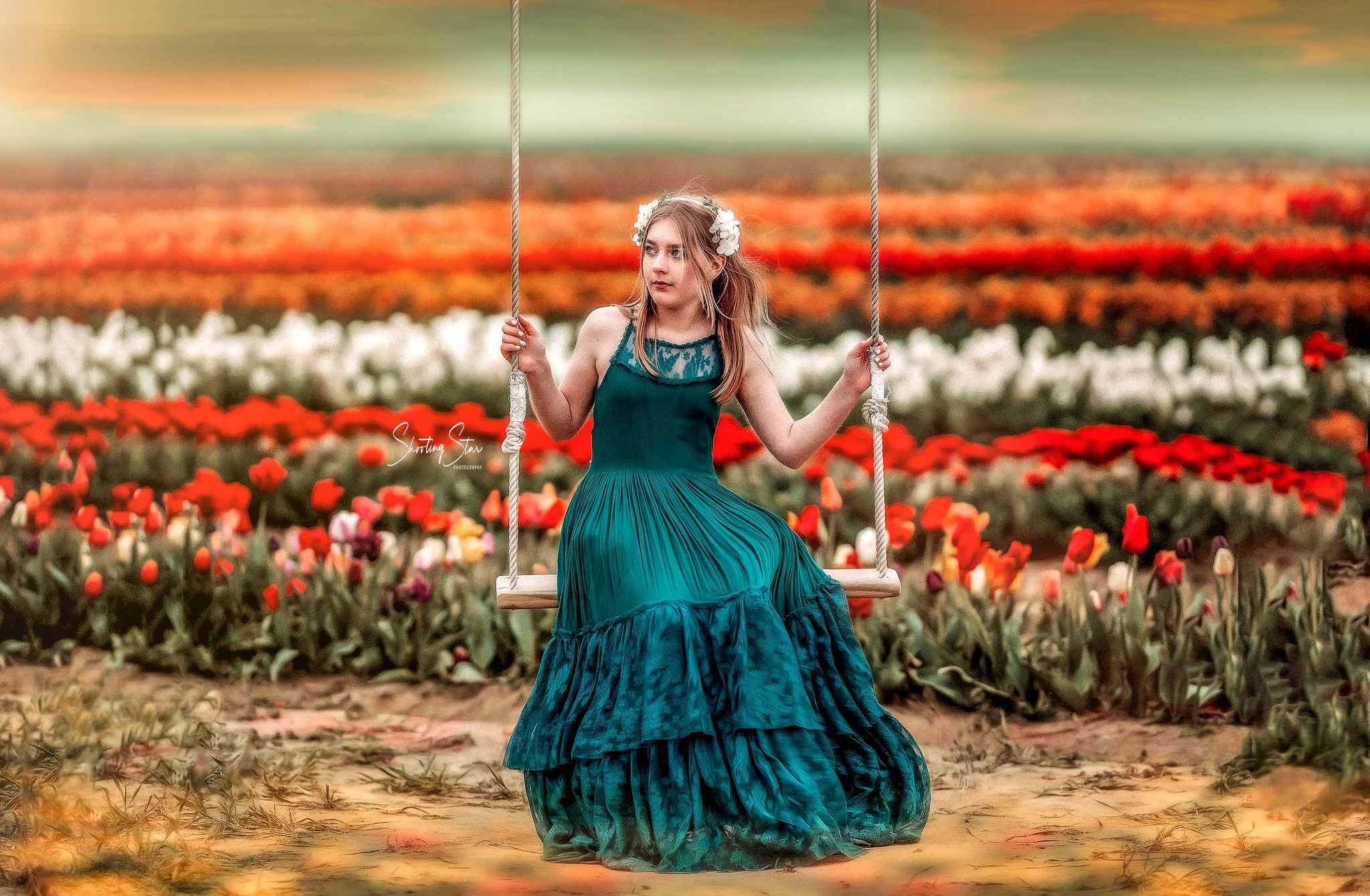 Girl in a green dress sitting on a swing at Dalton Farms in New Jersey during a spring portrait session