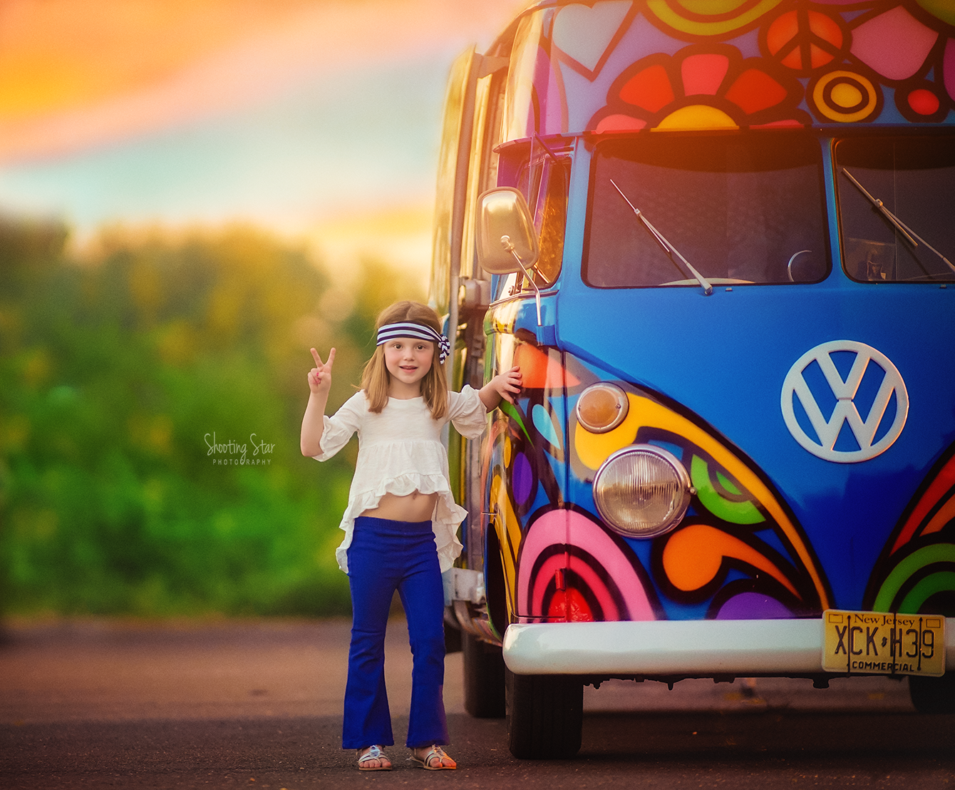 Girl holding up a peace sign beside a vintage VW bus during a fun and nostalgic photo session in South Jersey