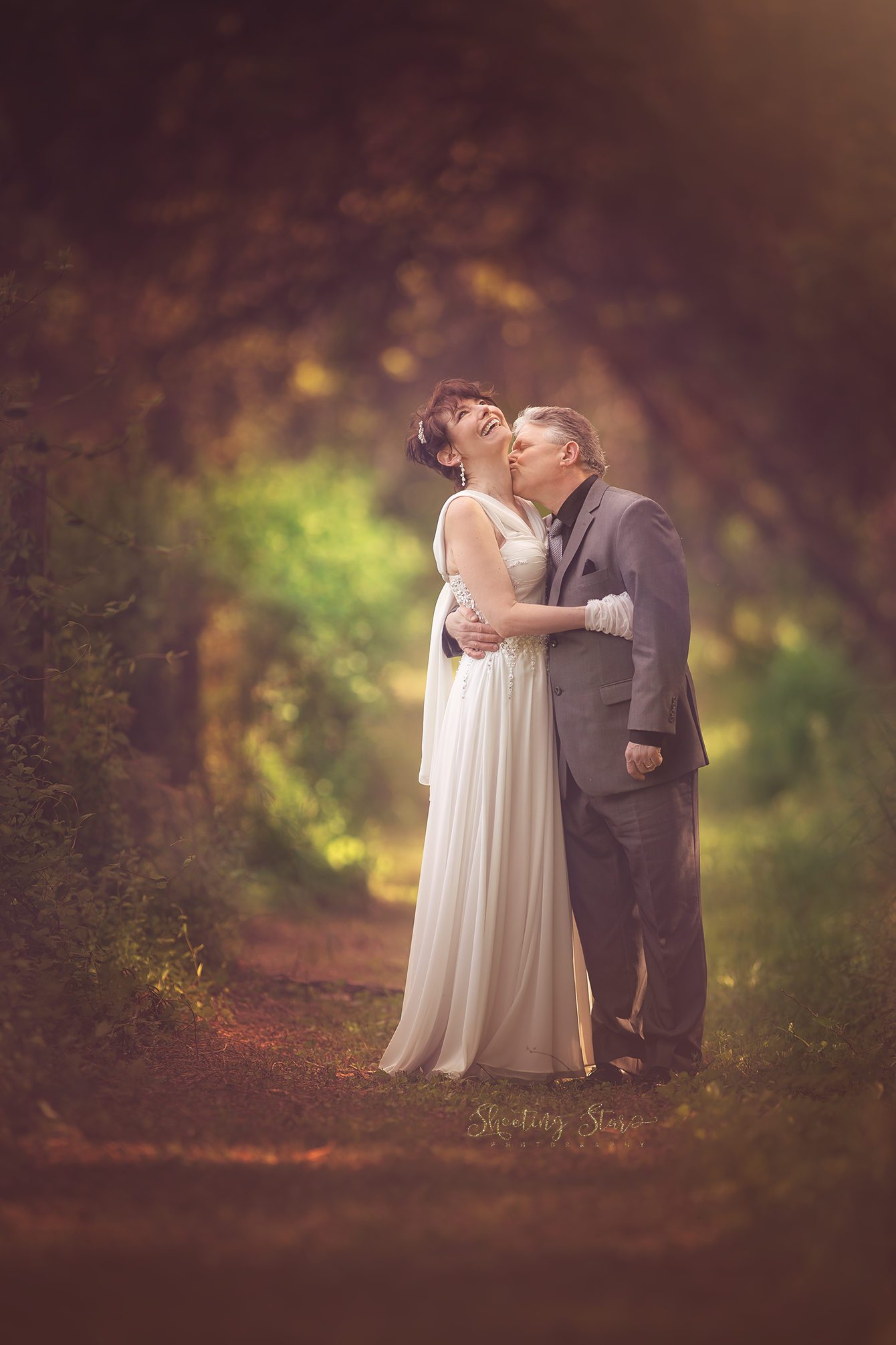 Intimate fine art couples portrait captruing a deeply emotional momment between partners in a natural outdoor setting.